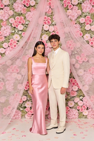 Couple in front of a pink floral wall.