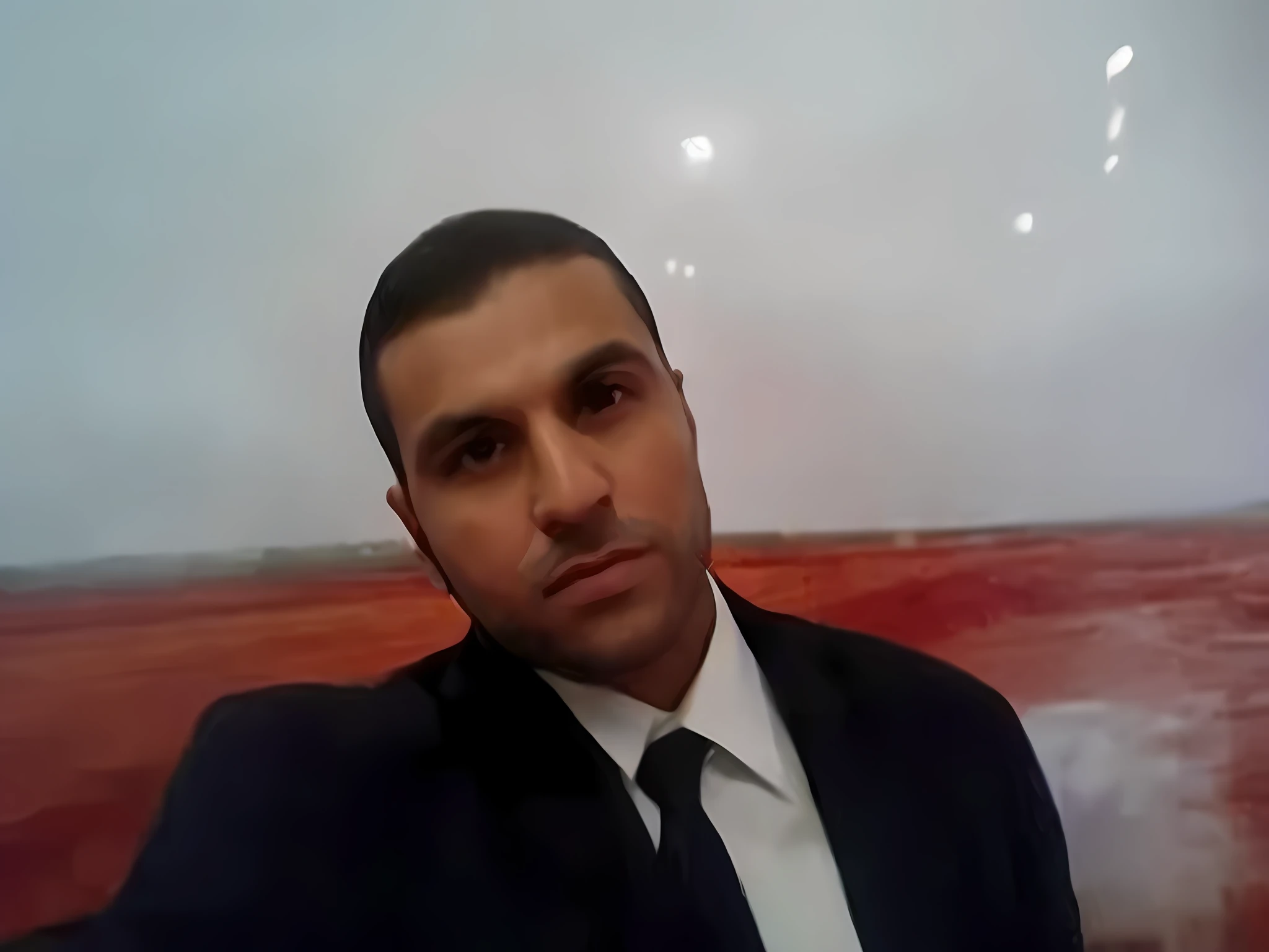 there is a man in a suit and tie sitting in front of a picture, amr elshamy, mohamed chahin, emad mostaque, ahmad merheb, mohamed reda, atef, ismail, hicham habchi, jamel shabbaz, comming, in egypt, kurdish lawyer, maher morcos, nasreddine dinet, professional picture