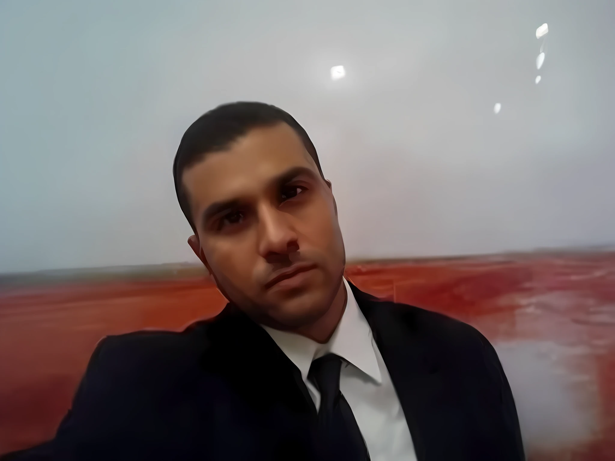 there is a man in a suit and tie sitting in front of a picture, amr elshamy, mohamed chahin, emad mostaque, ahmad merheb, mohamed reda, atef, ismail, hicham habchi, jamel shabbaz, comming, in egypt, kurdish lawyer, maher morcos, nasreddine dinet, professional picture