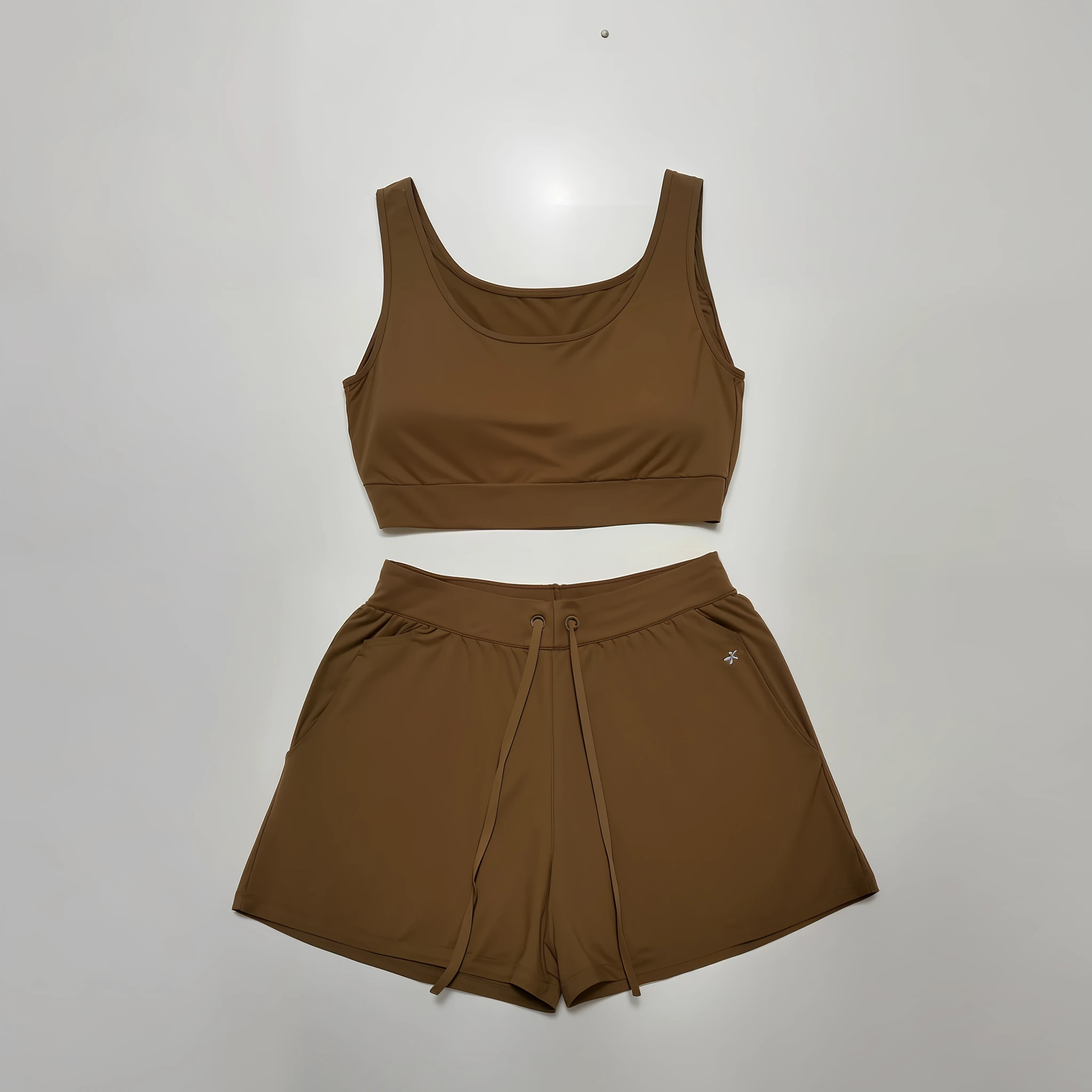 a close up of a brown top and shorts on a white surface, brown clothes, brown:-2, croptop and shorts, tan, muted brown, with two front pockets, short robust woman, bra and shorts streetwear, wearing a tank top and shorts, female outfit, product photo, two piece workout clothes, tan vest, ocher, sport bra and shorts
