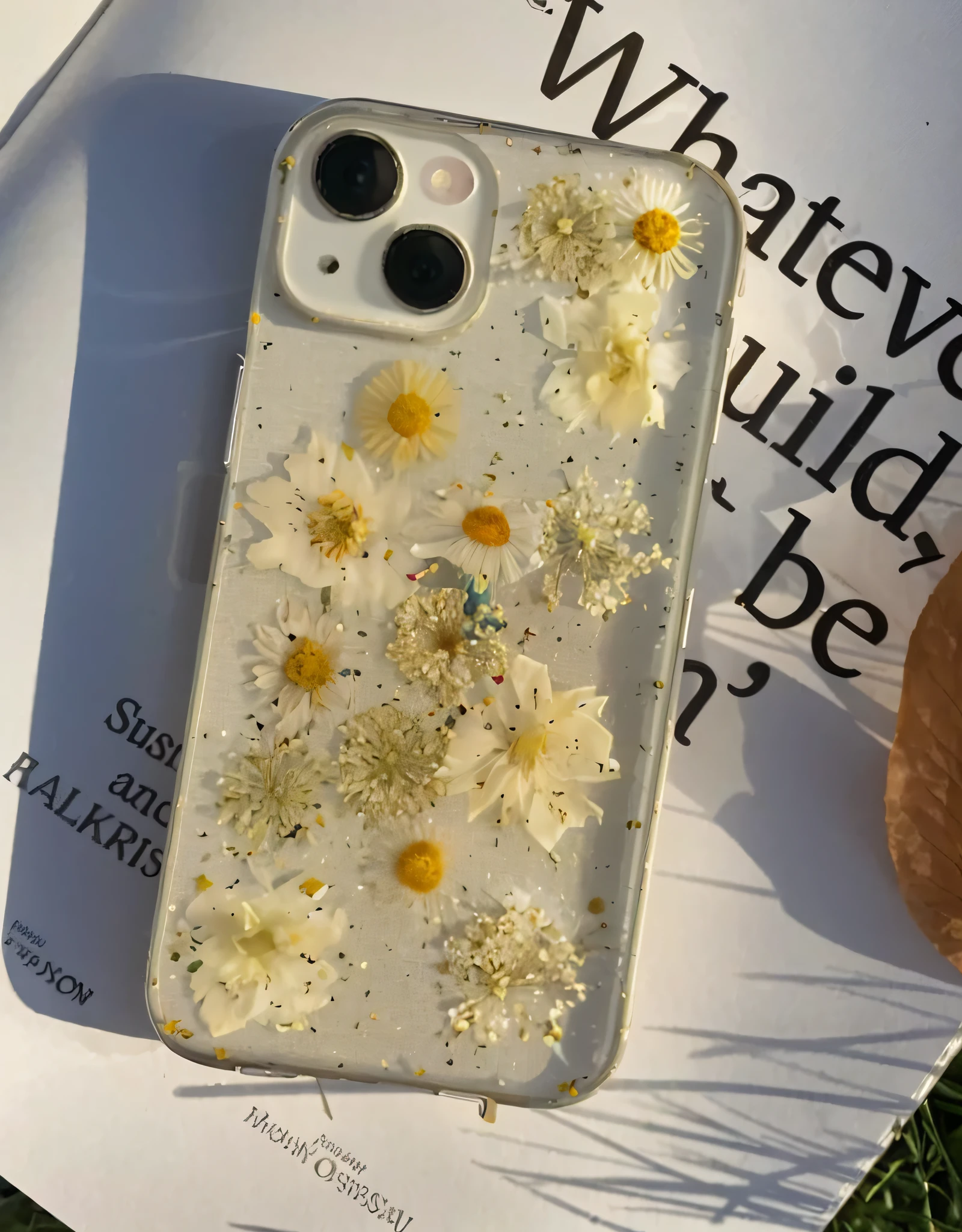 there is a phone case with flowers on it sitting on a book, gold flaked flowers, cell cover style, pressed flowers, with yellow flowers around it, flowery, made of colorful dried flowers, made of dried flowers, made of wildflowers, gold flowers, flower, iphone 12, 🤬 🤮 💕 🎀, patchy flowers, vibrant aesthetic
