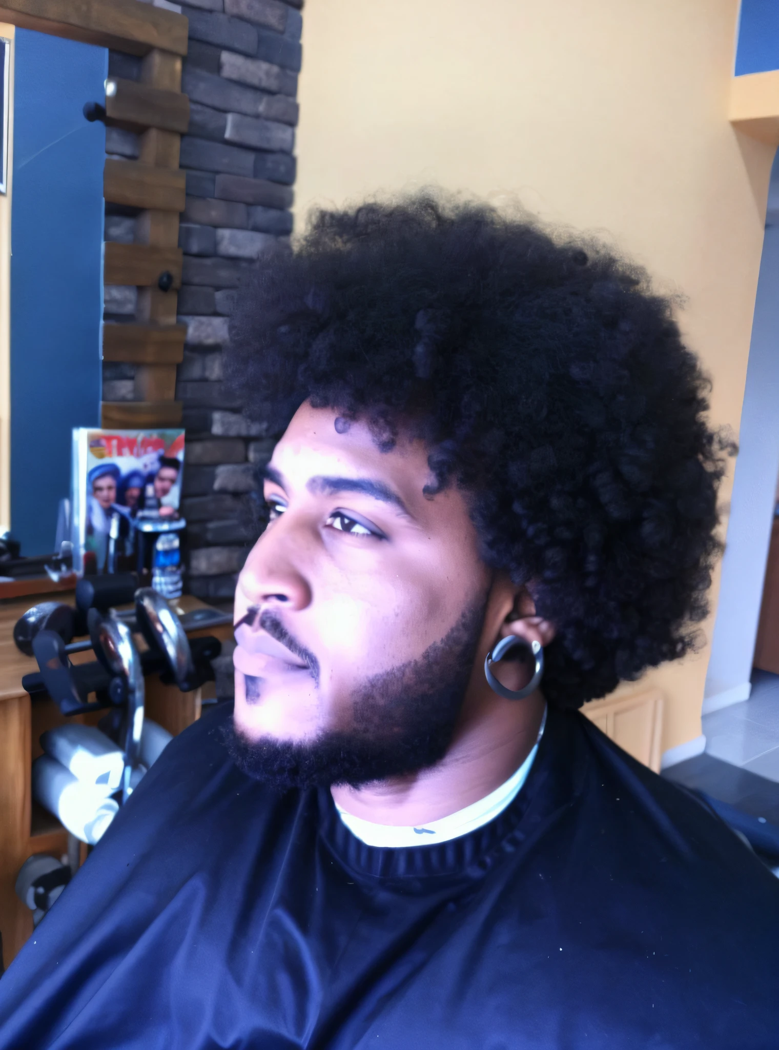 Arafed man with afro and beard sitting afro giant!, afro large, with background gym bodybuilding