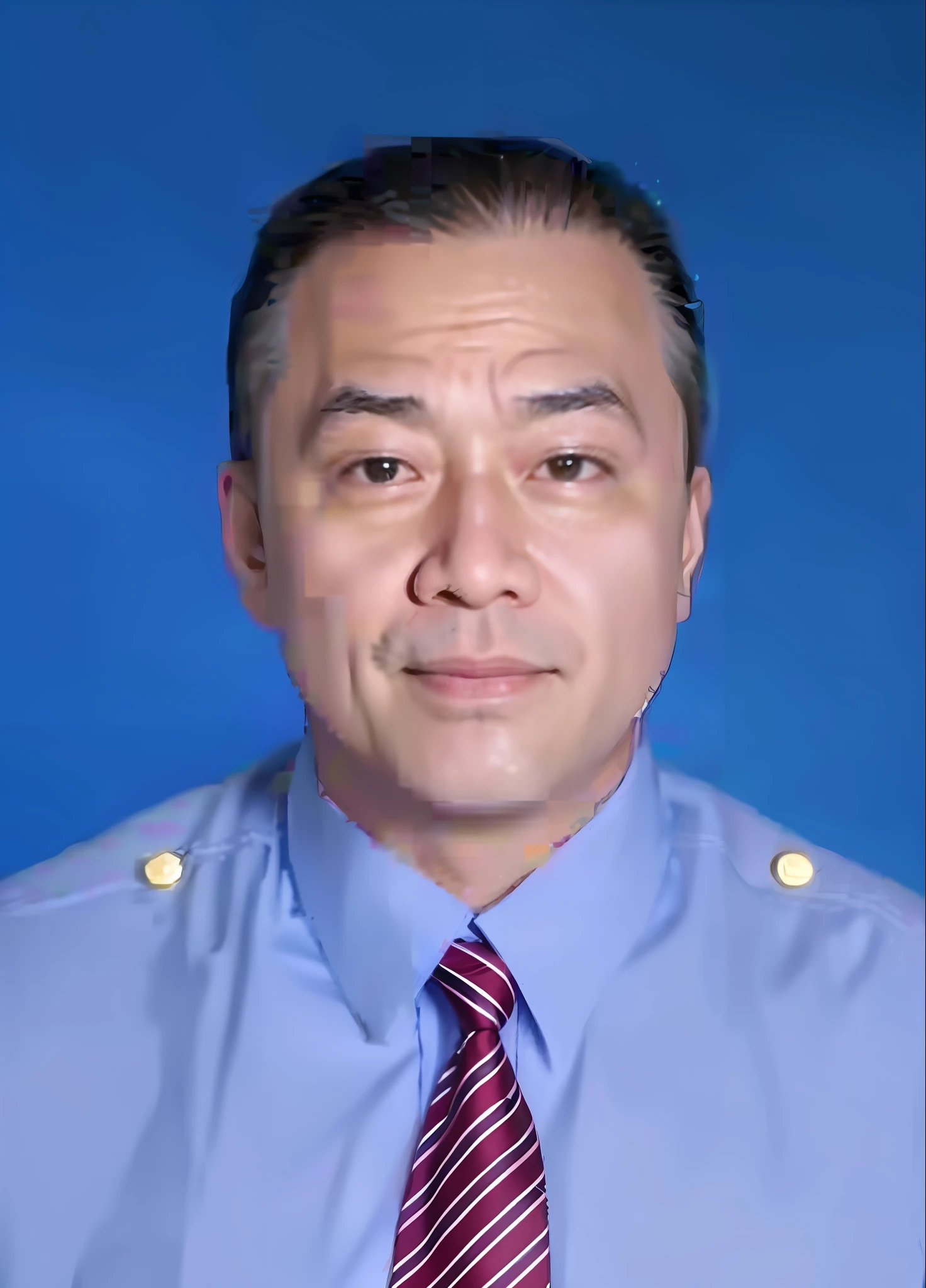 Asian man in blue shirt and tie, middle-aged with a bit of a beard