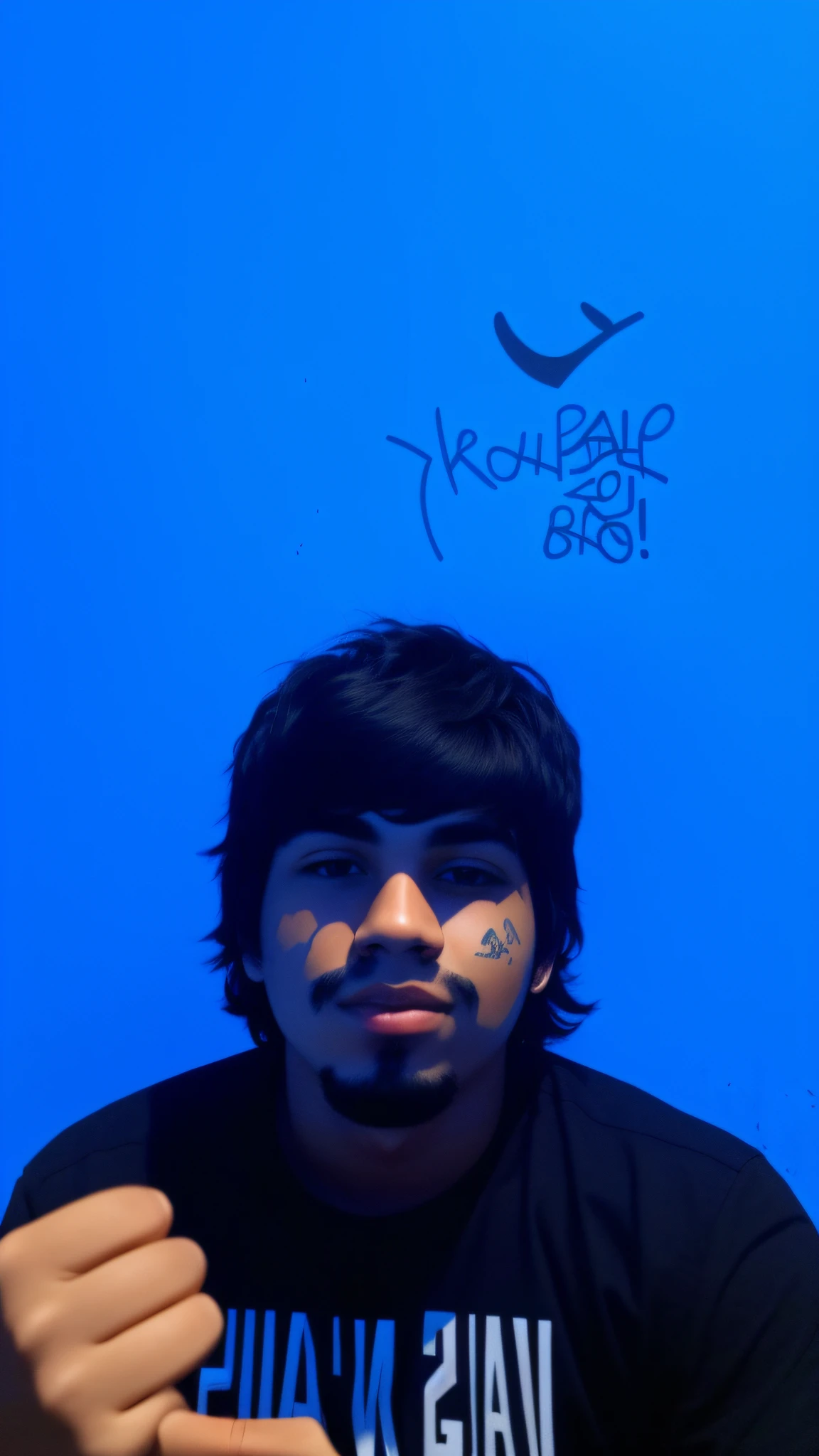 19 year old man, black shirt, black hair, graffiti