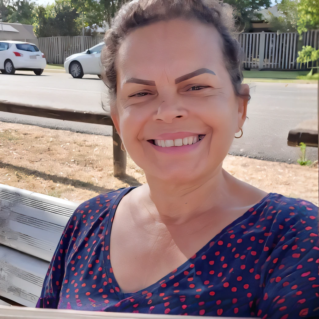smiling woman sitting on a bench in front of a fence, profile image, taken in the early 2020s, avatar image, profile picture, 4 5 yo, profile pic, 3 0 years woman, by Nándor Katona, photo taken in 2 0 2 0, facebook post, 3 5 year brazilian mother, she is about 6 0 years old