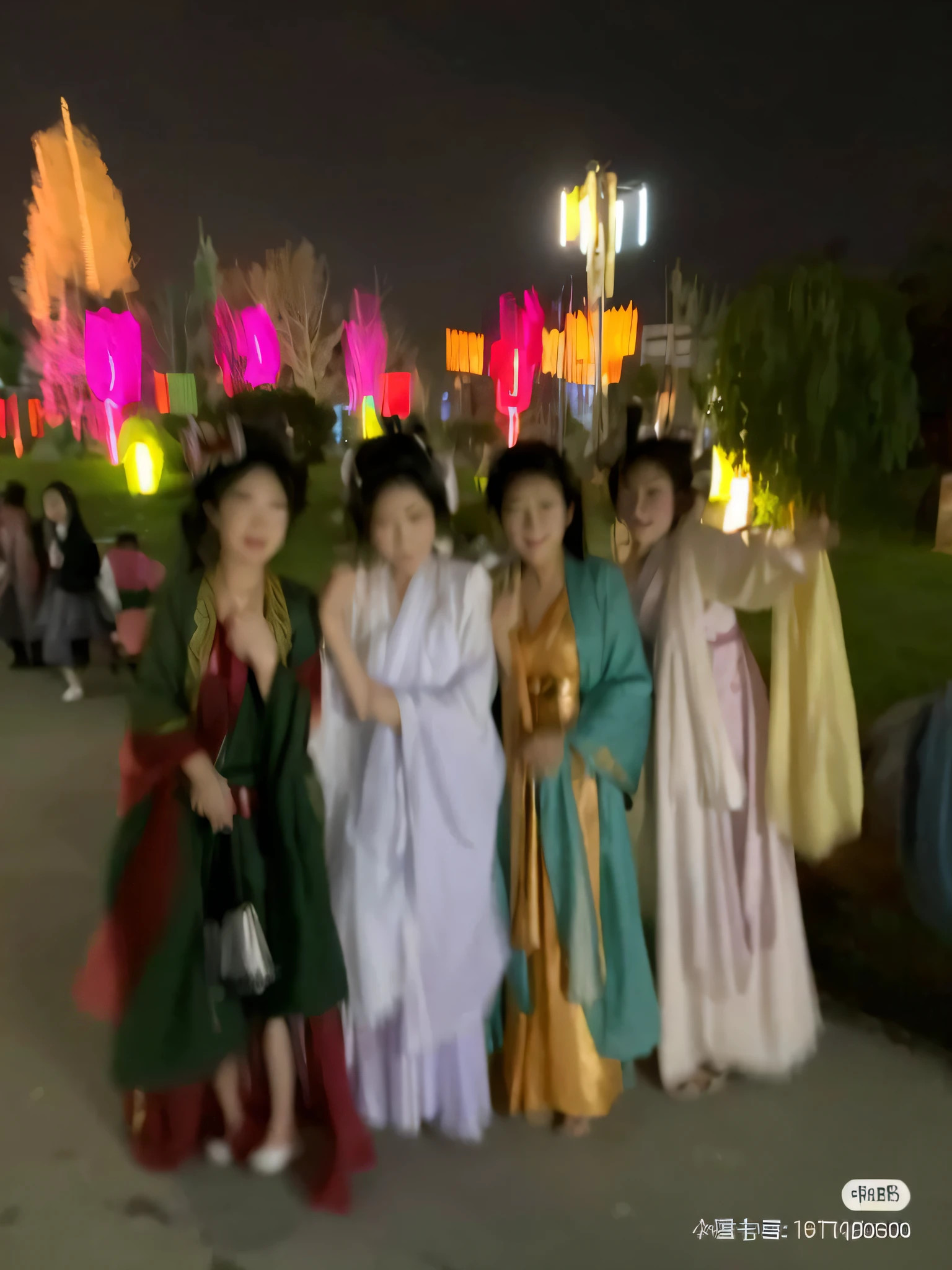 A few girls in Hanfu, Tang costumes stand in a row, time travelers appear in the park, intoxicating blur, photos taken at night, other women dancing in the back, colorful robes, flowing hair and robes, at night, shot with the best DLSR camera, princess in the foreground, very beautiful, flowing robes