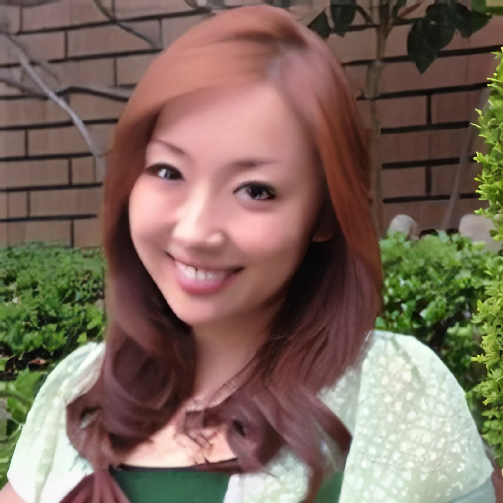 Smiling woman with red hair and green shirt in front of bushes, photo, masterpiece, top quality