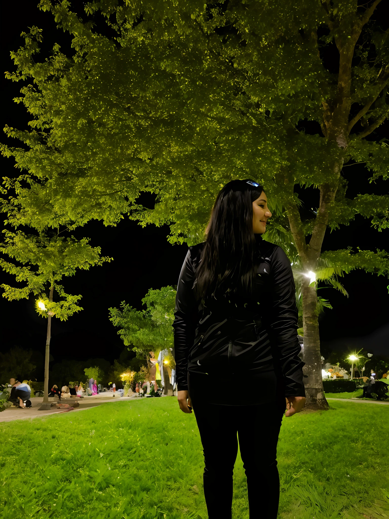 There is a woman standing in front of a tree in a park, photo taken at night, photo taken at 2 0 2 0, profile picture, taken in early 2020, at night, having a great time, 3 0 year old woman, photo of a woman, 30 year old woman from Cuba, with a park in the background,  year 3000, future