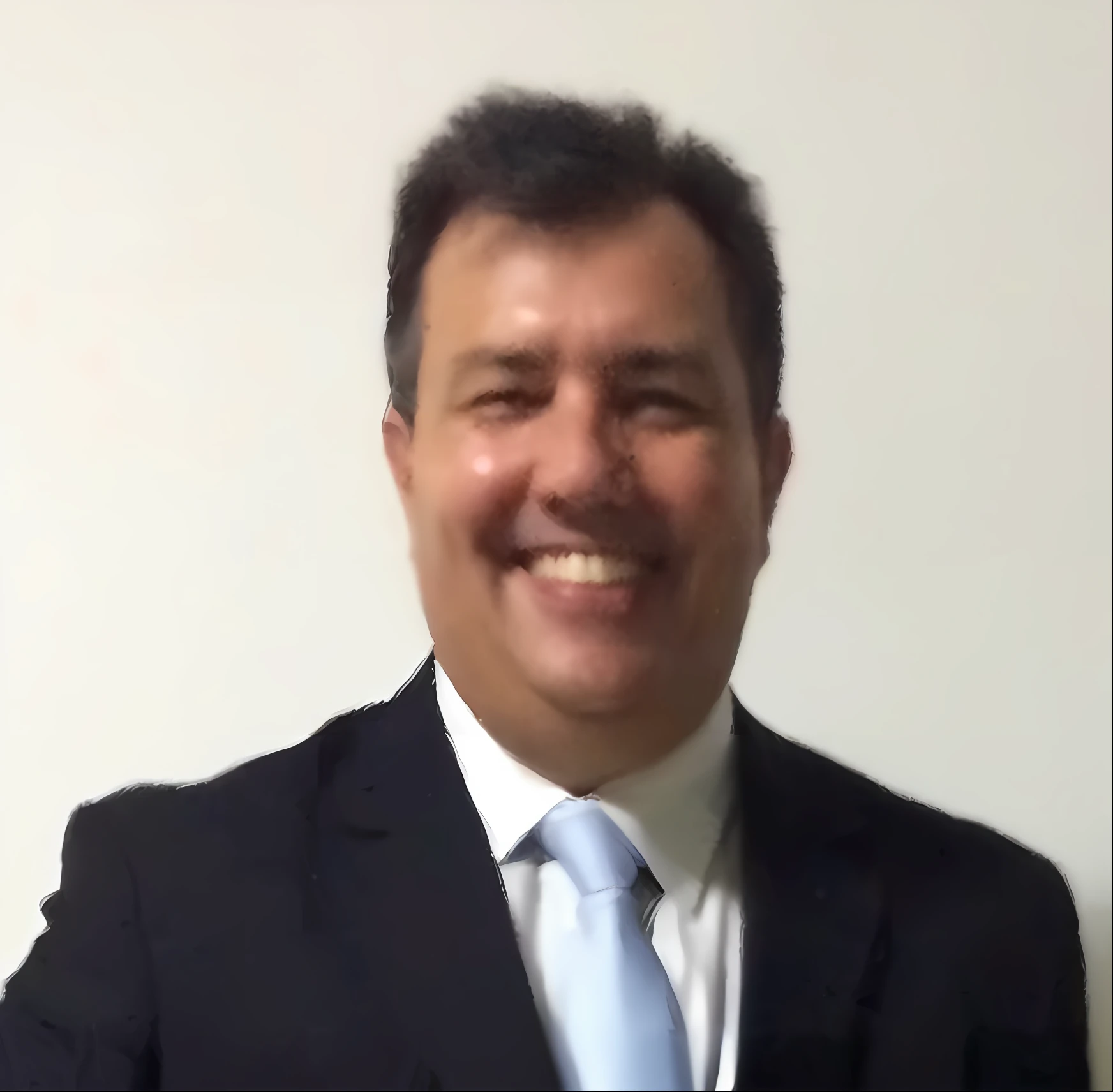 smiling man in a suit and tie standing in front of a white wall, david rios ferreira,