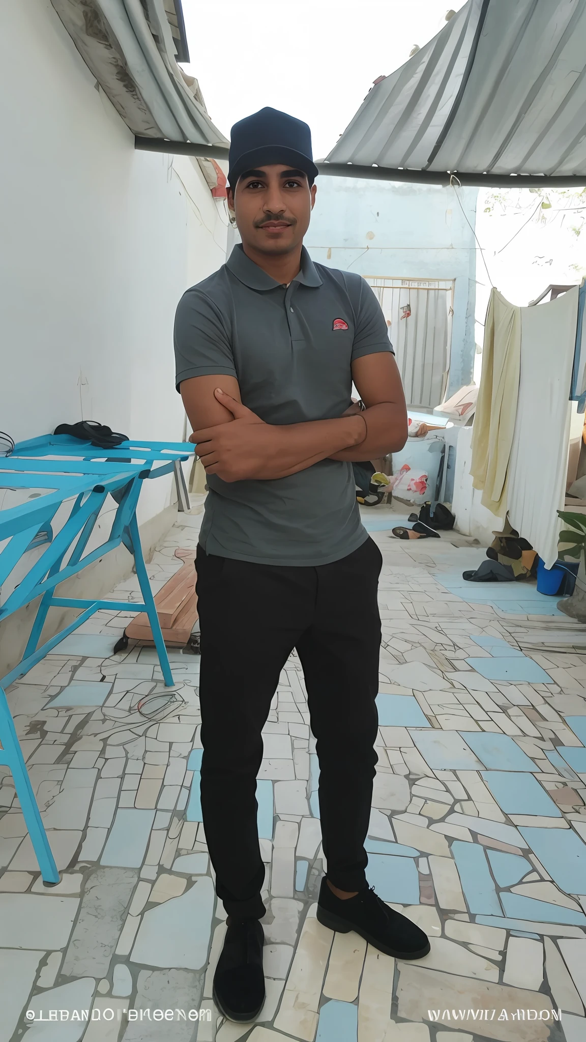 arafed man standing in a room with a blue chair and a blue table, Mohamed Chahin, imagem de corpo inteiro, Alex, Mohamed Reda, Riyahd Cassiem, em torno de 1 9 anos, fotografia de corpo inteiro, ele tem cerca de 2 0 anos de idade, ele tem cerca de 20 anos, Fotografia tirada em 2 0 2 0, Atef