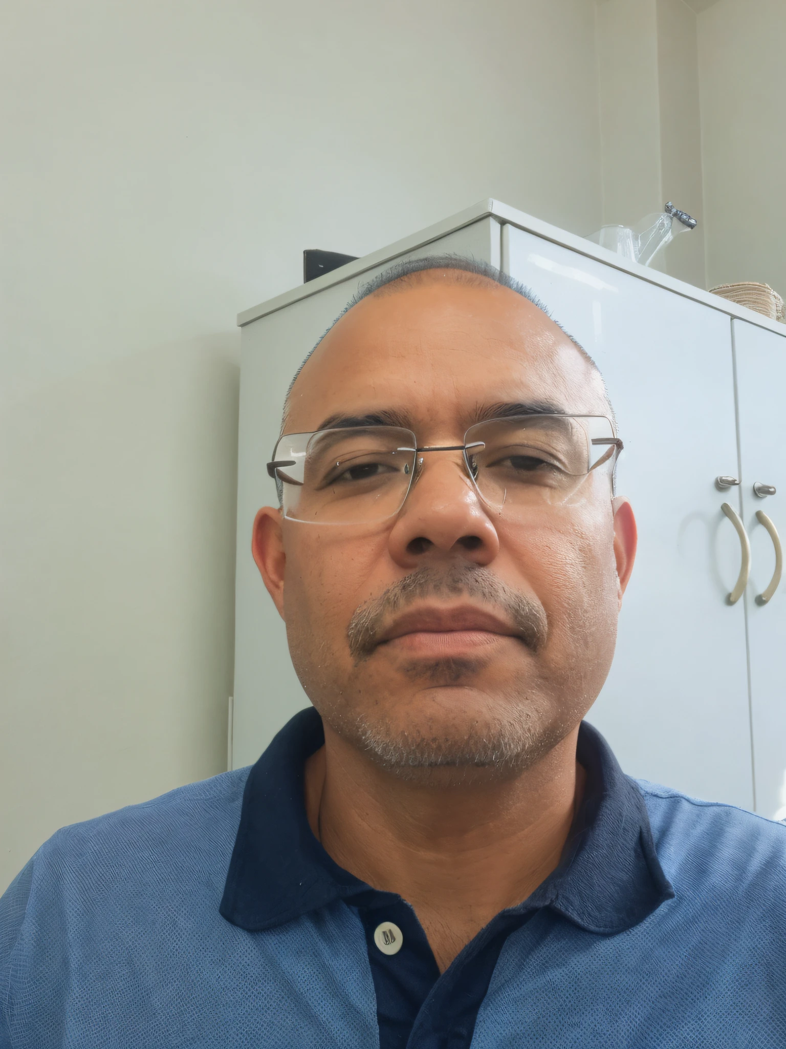 There is a man, chalk, brown eyes, bald, with glasses and blue shirt looking at the camera, front photo, 48-year-old man, front facing camera, front face, frontal shot, (48 years), Andres Rios, about 45 years old, front view, anime style