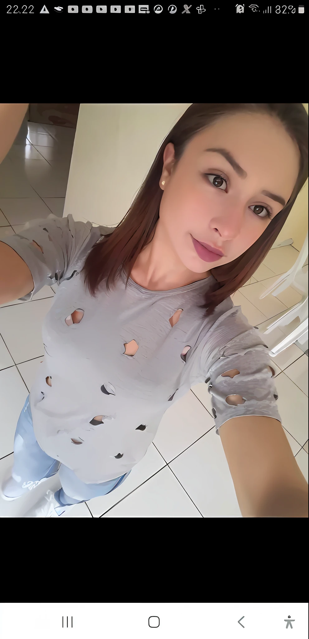 arafed woman taking a selfie with her cell phone in a bathroom, torn shirt, ripped clothing, in tshirt, gray shirt, by Nándor Katona, wearing in shirt, malika favre, 2 4 year old female model, fernanda suarez, lola dupre, beutifull, looks like fabiula nascimento, marischa becker