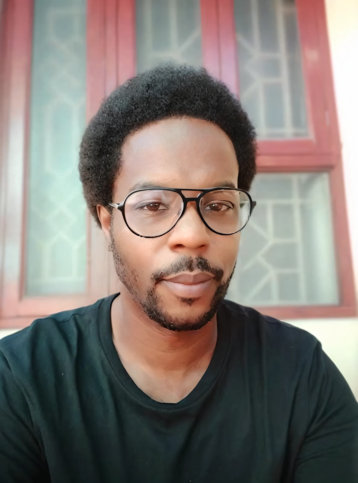 there is a man with glasses and a beard sitting in front of a window, mohamed chahin, david uzochukwu, 8k selfie photograph, riyahd cassiem, avatar image, george pemba, by Ismail Gulgee, emmanuel shiru, thomas kinkaide, by Chinwe Chukwuogo-Roy, profile photo, without beard