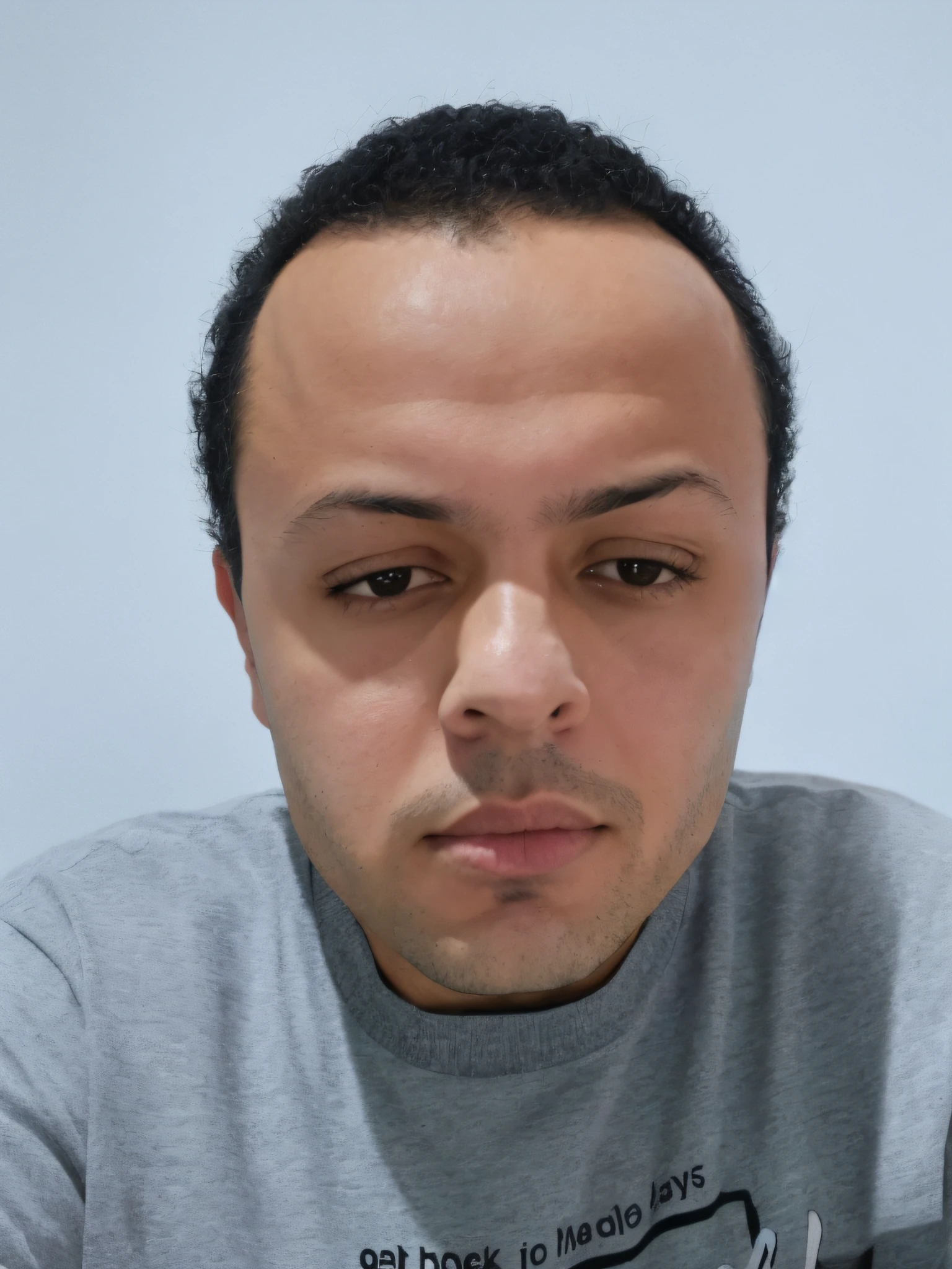 there is a man with a gray shirt looking at a cell phone, aykut aydogdu, headshot profile picture, frontal picture, with serious face expression, taken in the early 2020s, 8k selfie photograph, mohamed chahin, taken in the late 2000s, with no facial features, riyahd cassiem