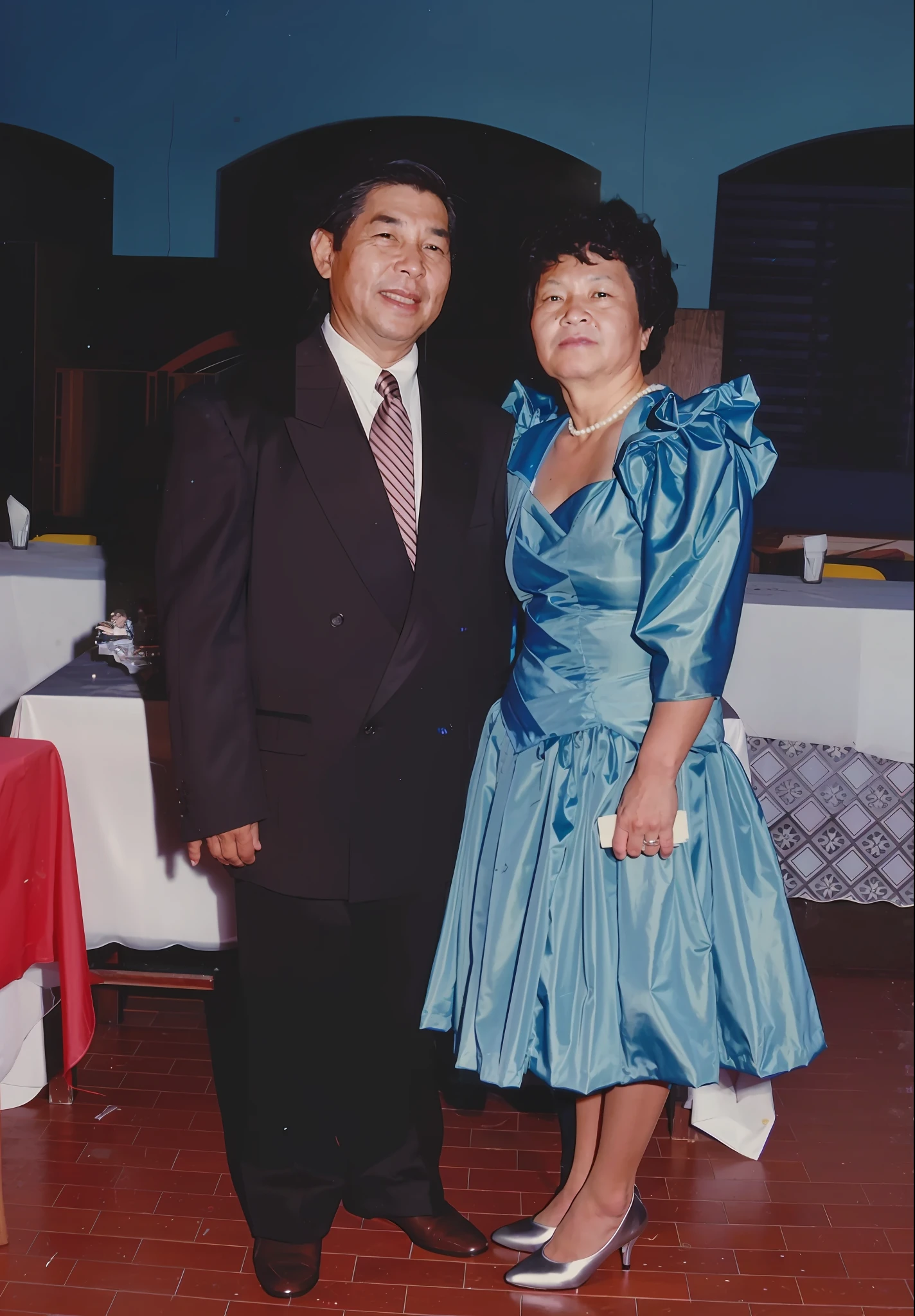 They are standing in a room with tables and chairs, Mom and Dad, photo 1 9 9 0 s, photo 1980s, photo 1 9 8 0 s, taken in the late 1980s, photo of the 80s, photo taken in 1989, of more quality photo