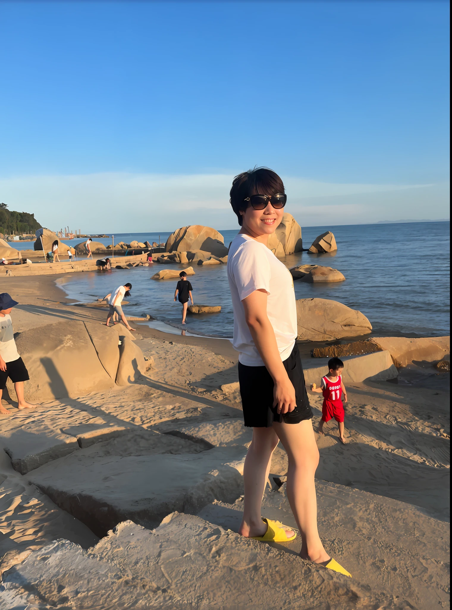 there is a woman standing on a beach with a , standing at the beach, at beach at sunset, standing near the beach, vacation photo, sunny day at beach, photo taken in 2 0 2 0, the ocean in the background, at the beach, in the beach, posing on a beach with the ocean, taken with sony alpha 9, nice afternoon lighting