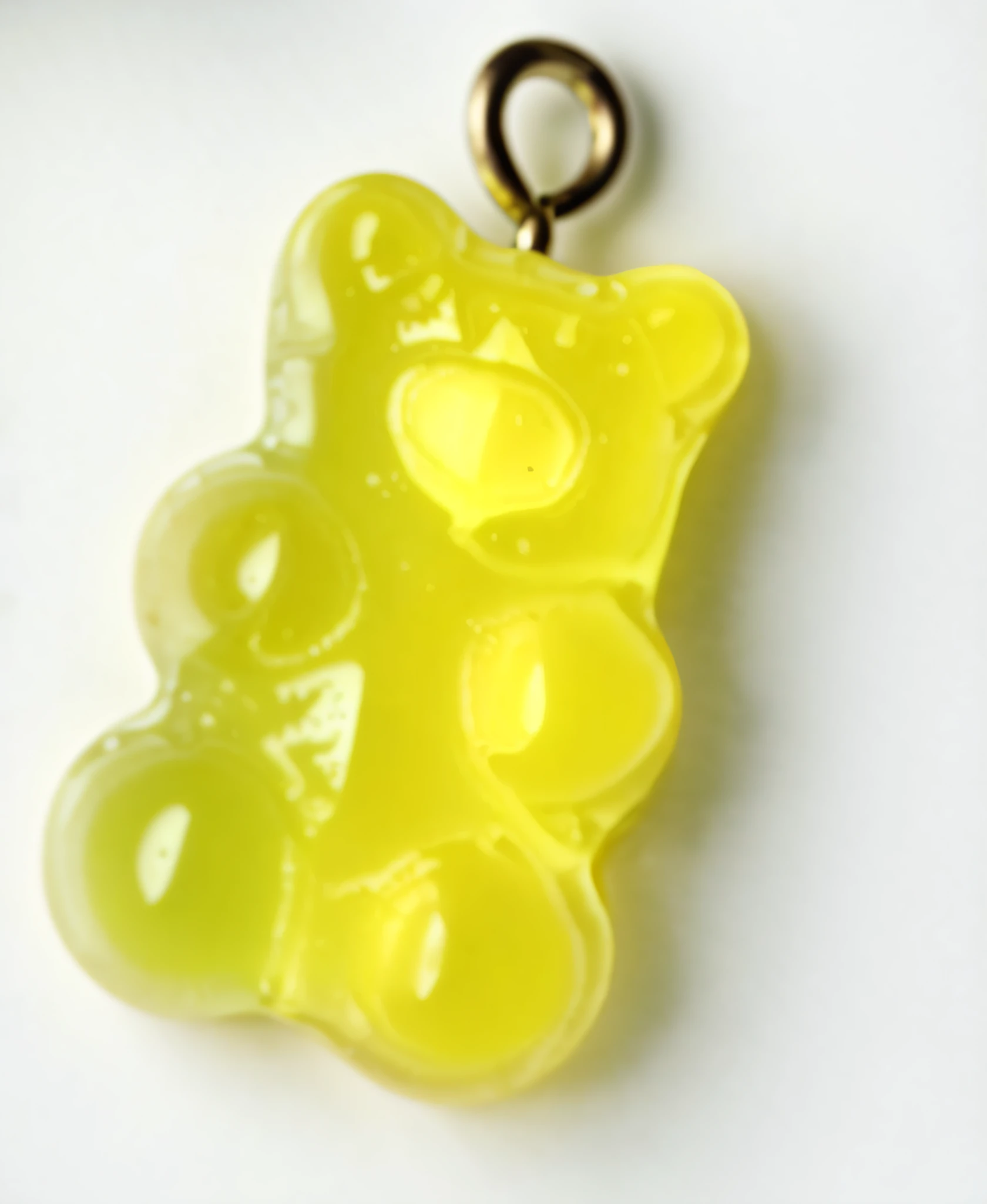 there is a yellow gummy bear pendant on a white surface, gummy bear, gummy bears, resin, vivid), reverse, acrylic, with a bright yellow aureola, u. h. d, made of glowing wax, made of glazed, 1/320, garish, yum, 5 d, 5d, juicy, sofubi, glossy yellow