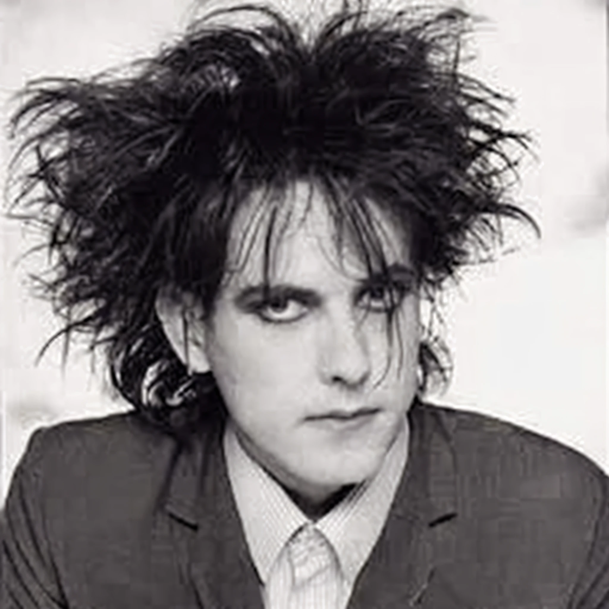 A closeup of a person with a hairstyle and a suit, The Cure, he has dark hair, hair lumps, Edward, Cure, Rossdtaws, a picture of a shaggy, burtonese man with haunted eyes and crazy hair, his hair is messy and disheveled, his hair is messy and wild, disheveled