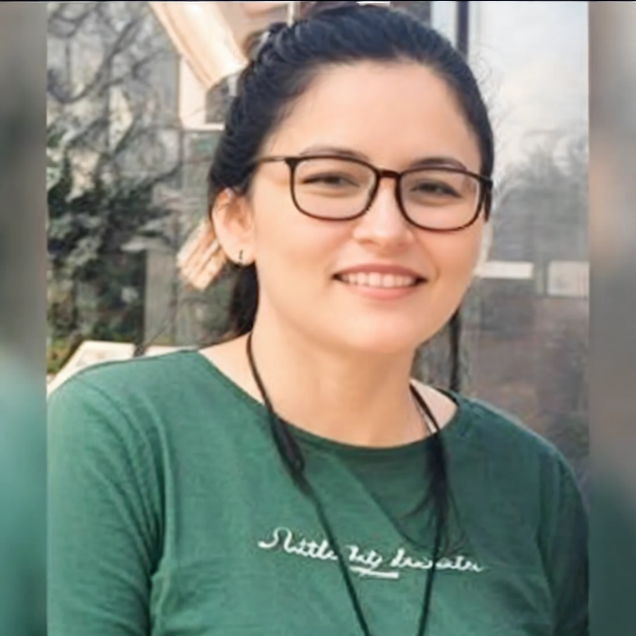 Woman in green shirt and glasses smiling for a photo, 30 year old woman, profile picture, realistic