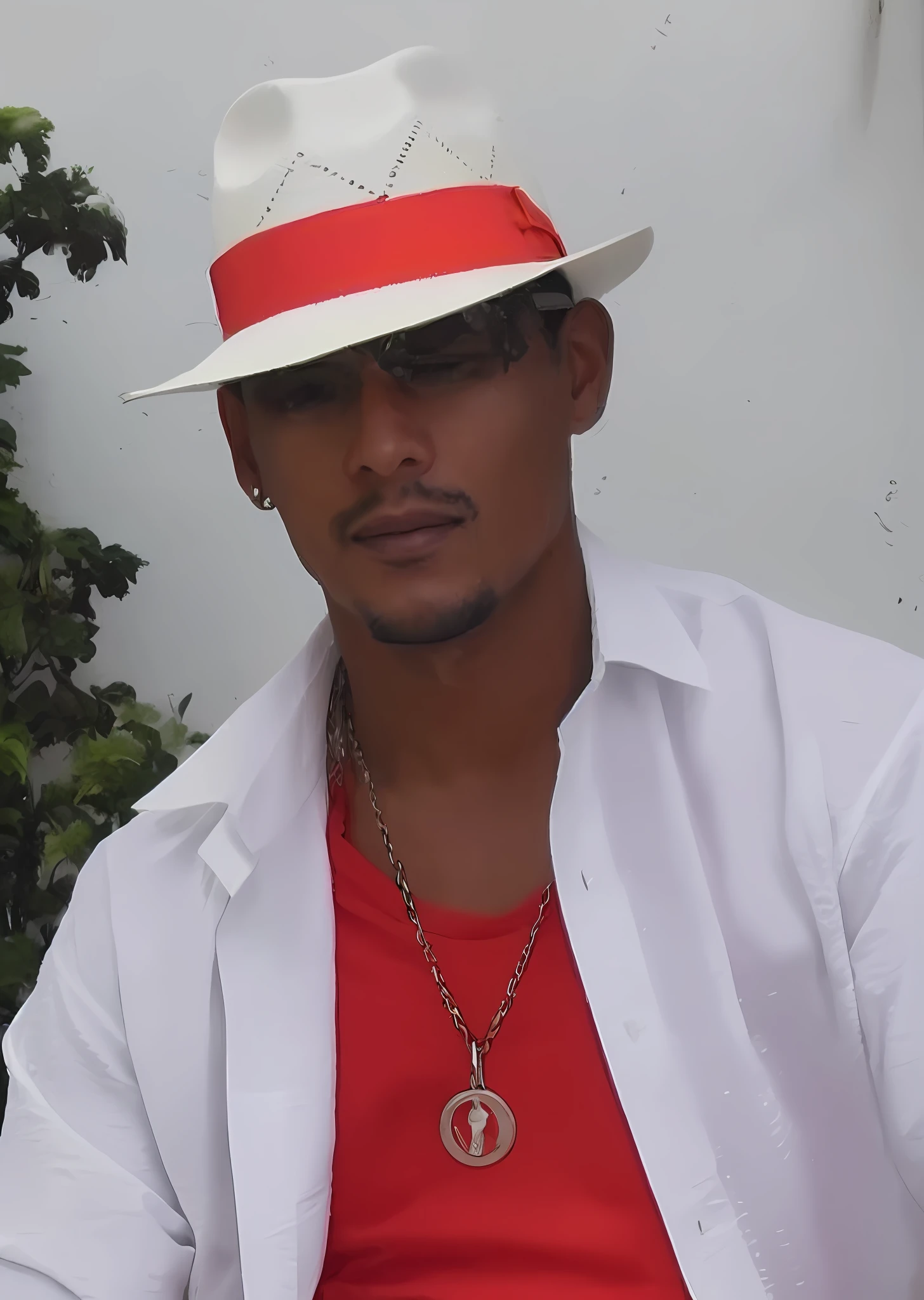 A man in a white hat and red shirt,