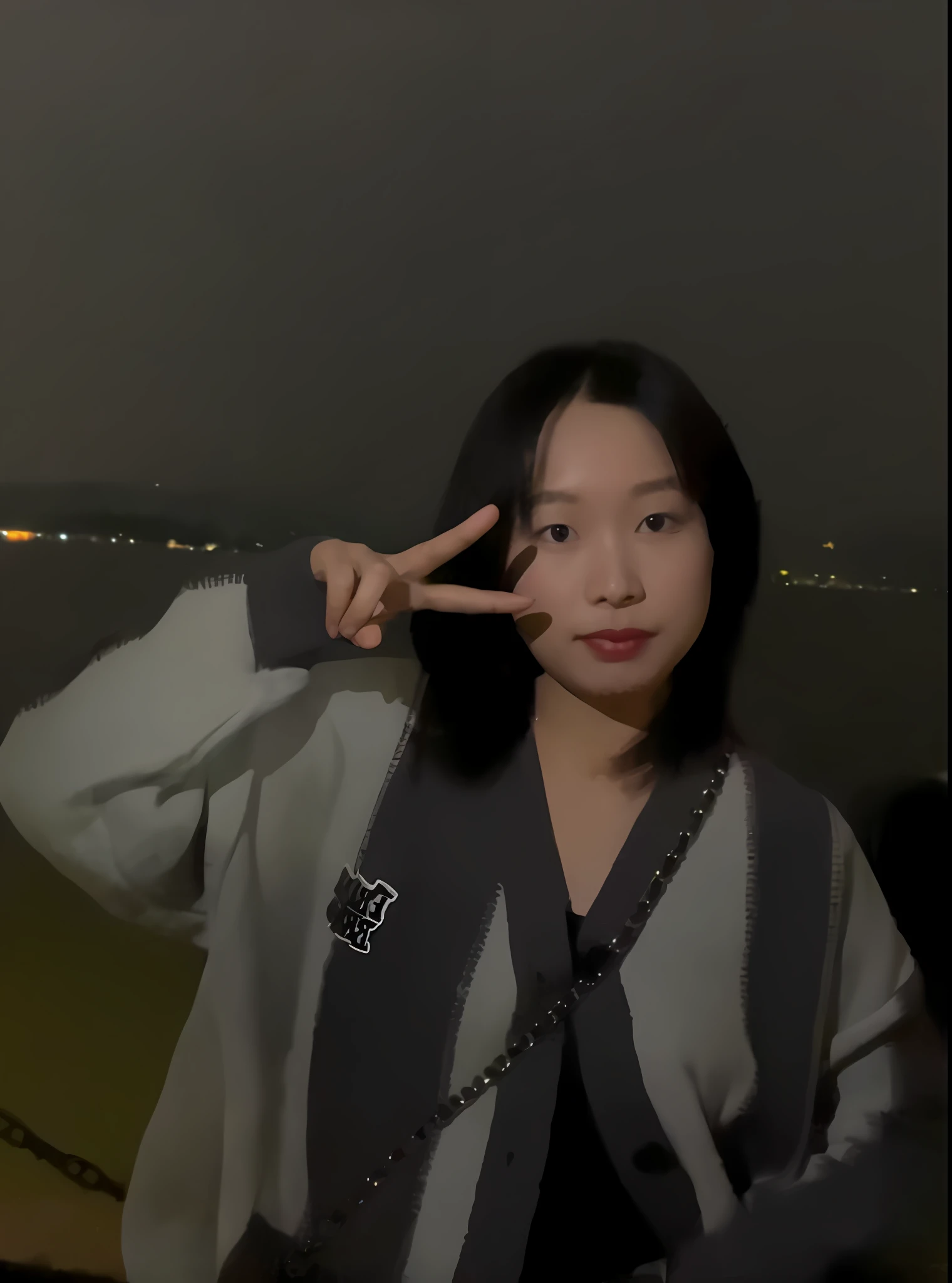 there is a woman that is standing by the water making a peace sign, ☁🌪🌙👩🏾, xintong chen, very very low quality picture, jaeyeon nam, wenfei ye, with short hair, heonhwa choe, korean girl, with sunset, profile picture 1024px, profile pic, chiho, with glowing lights at night