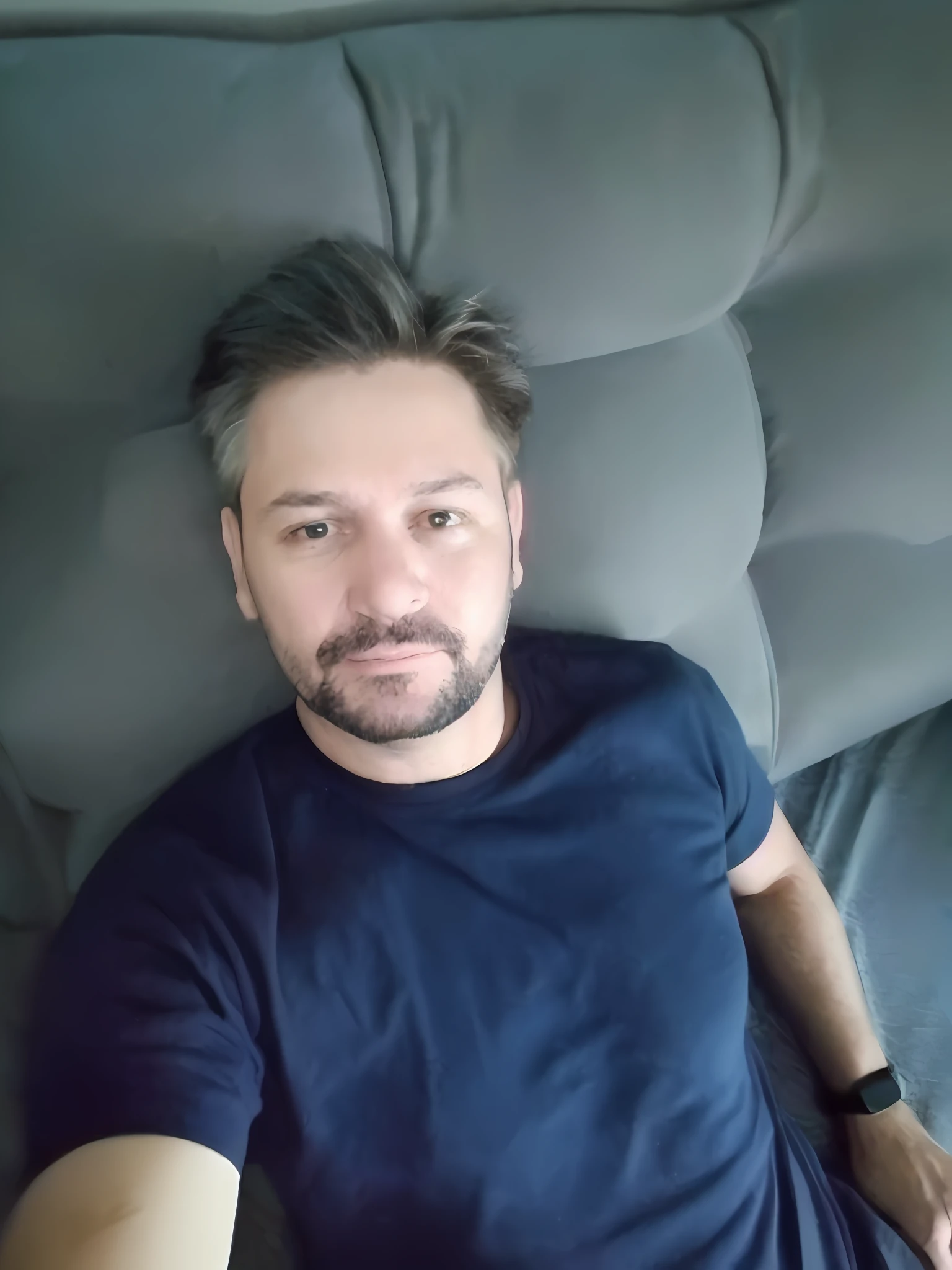 arafed man laying on a couch with a remote control in his hand, 4 0 years old man, about 3 5 years old, 45 years old men, profile image, relaxing after a hard day, selfie of a man, profile picture, 3 6 years old, 38 years old, 5 0 years old man, 8k selfie photograph