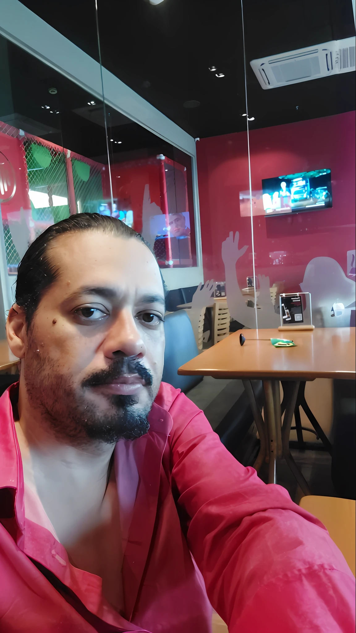 there is a man sitting at a table with a cell phone in his hand, taken in the early 2020s, very very low quality picture, (38 years old), about 3 5 years old, 8k selfie photograph, andres rios, 4 0 years old man, taken in the late 2000s, juanmao, in a taco bell