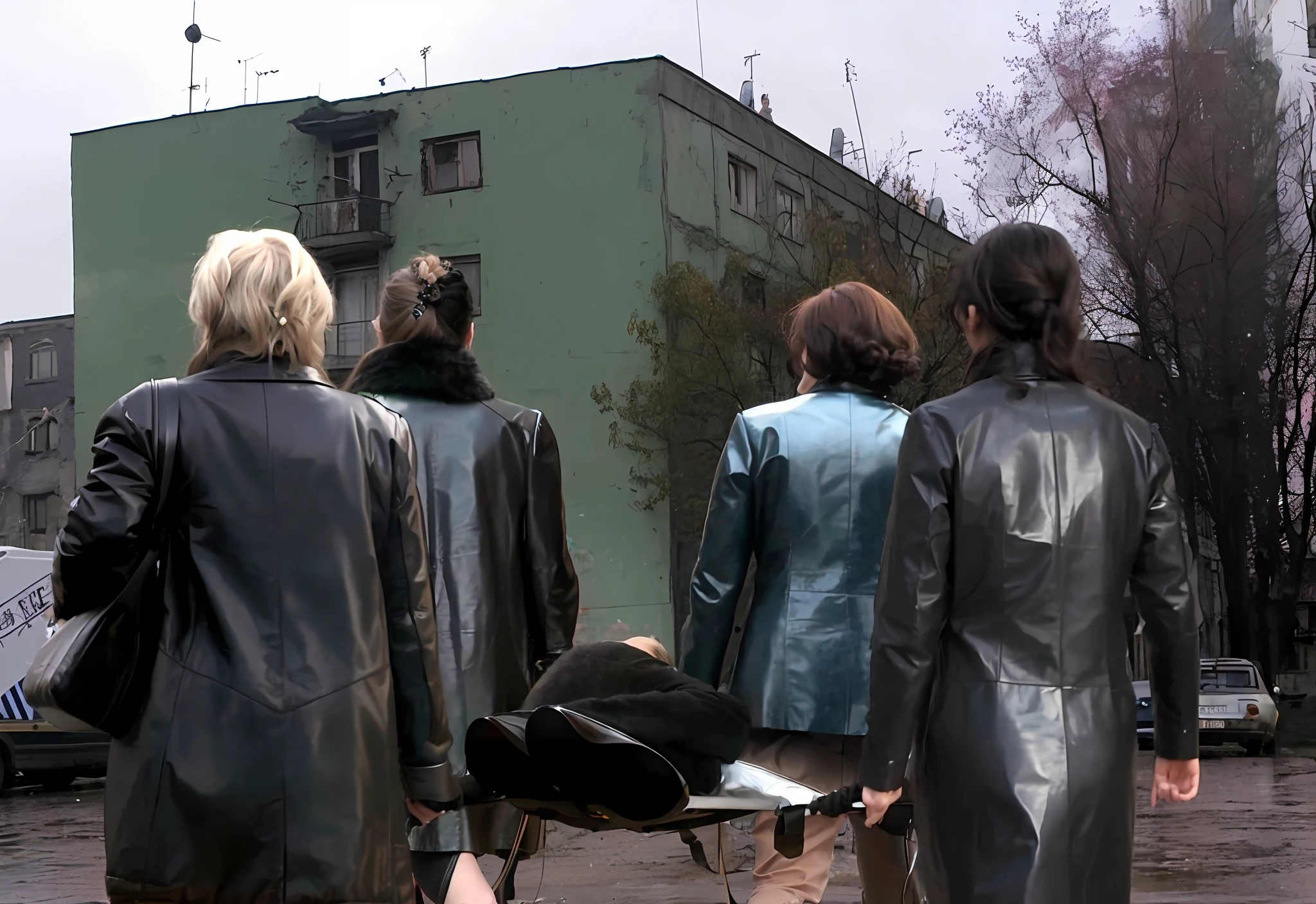 several longhaired women in shiny long leather coats are walking down a street while carrying a stretcher, an elderly man is been carried on a stretcher, women are carrying a man on a stretcher, women in shiny coats are carrying a stretcher in the street, dramatic pose, theatralic rescue pose, first aid scene, shiny clothed women in a rainy street, a writhing man is lying on a stretcher, a stretcher in a russian demolished street, , photo still of behind view, dead bodies in the background, rear-shot, in postapocalypse city, video still, still from a music video, scene from the film, still from a movie, shot from movie, still from the film, still from l'estate, opening scene