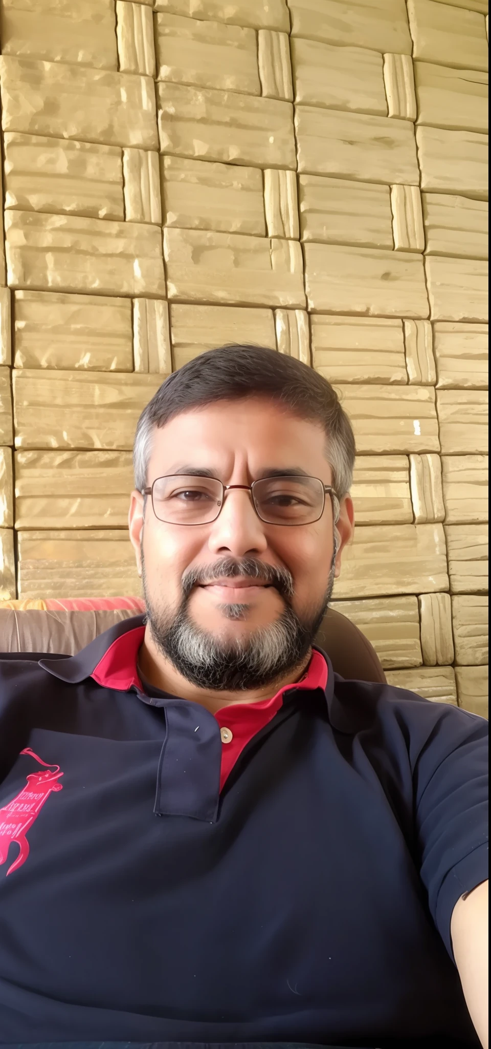 arafed man sitting on a couch with a remote control in his hand, inspired by Narayan Shridhar Bendre, ranjit ghosh, inspired by Bikash Bhattacharjee, by Rajesh Soni, emad mostaque, inspired by Sudip Roy, selfie photo, mohamed chahin, sayem reza, photo taken with sony a7r camera