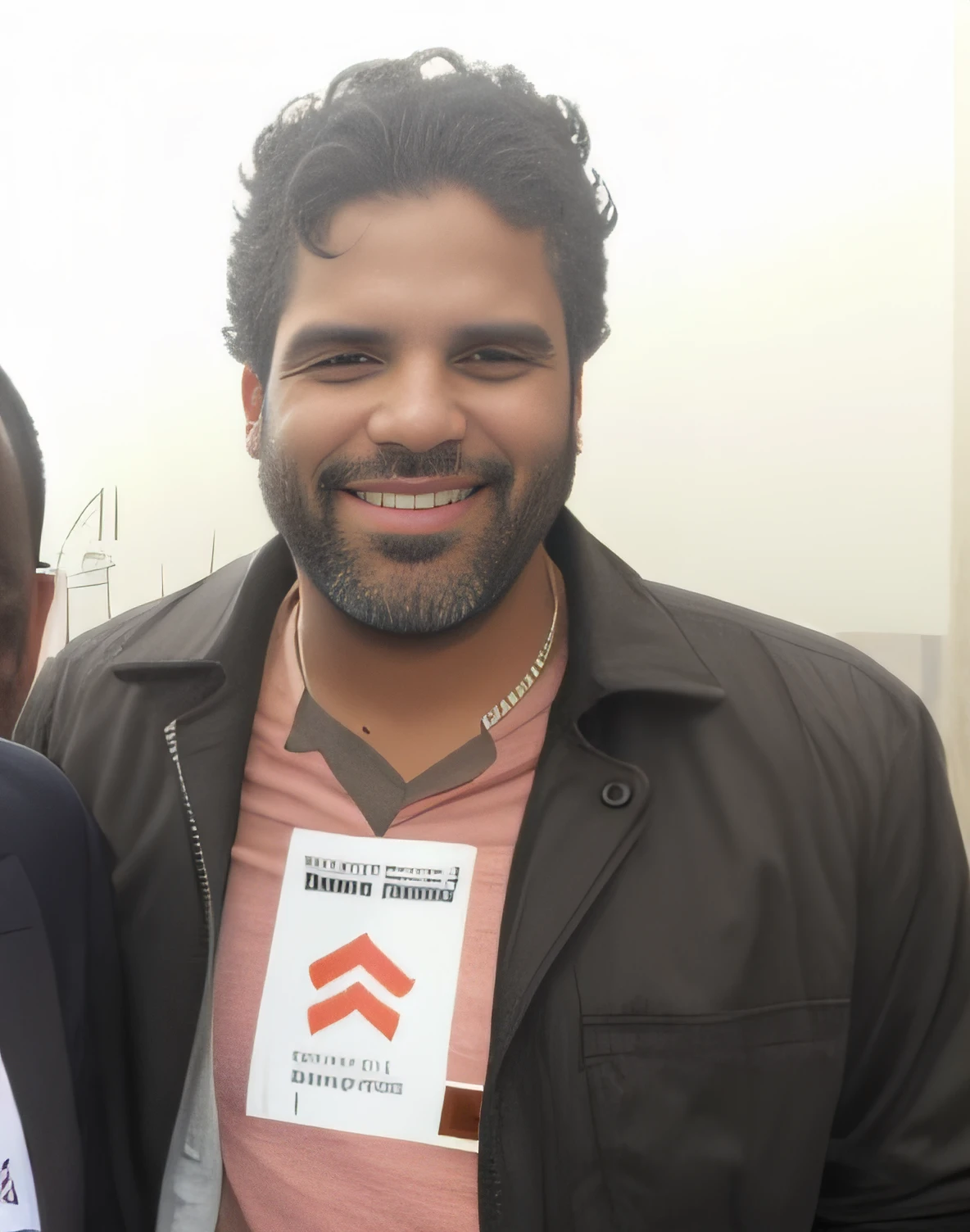 smiling man in a pink shirt and black jacket holding a sign, icaro carvalho, edu souza, caio santos, in sao paulo, by Giorgio Cavallon, by Emerson Silva, by Samuel Silva, dan dos santos, david rios ferreira, federico pelat, joe alves, by Matteo Pérez, by João Artur da Silva, andrea rocha