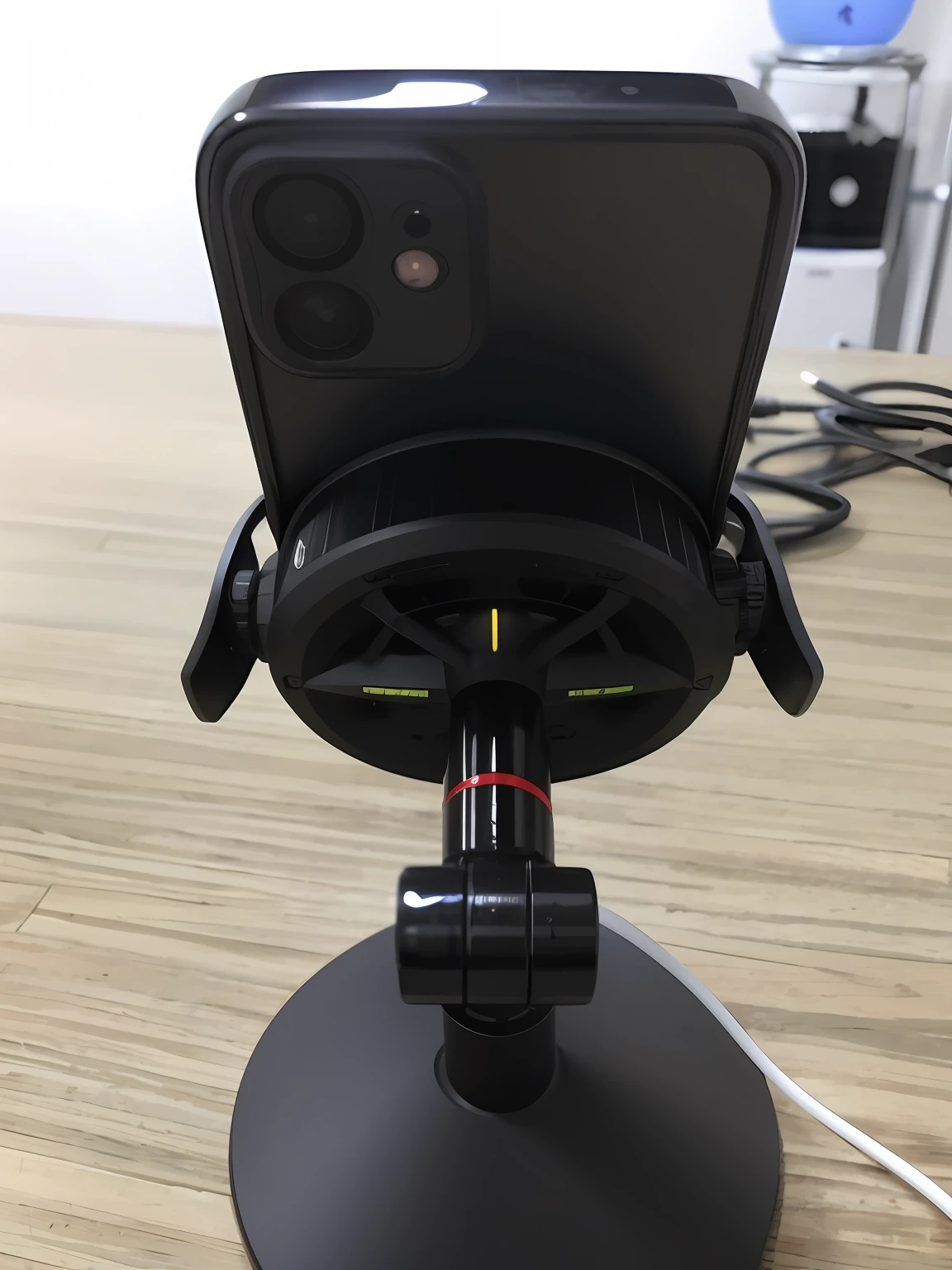 There is a mobile phone on the stand on the table in the live broadcast room with a wide-angle lens, camera angle shot from below, bottom view, wide-angle view, detailed wide-angle lens, low-angle camera view, middle view, front view, tilt camera angle, wide-angle POV close-up, viewing movie view from a lower angle, there is a watch under the phone, and there are beautiful women in the live broadcast room