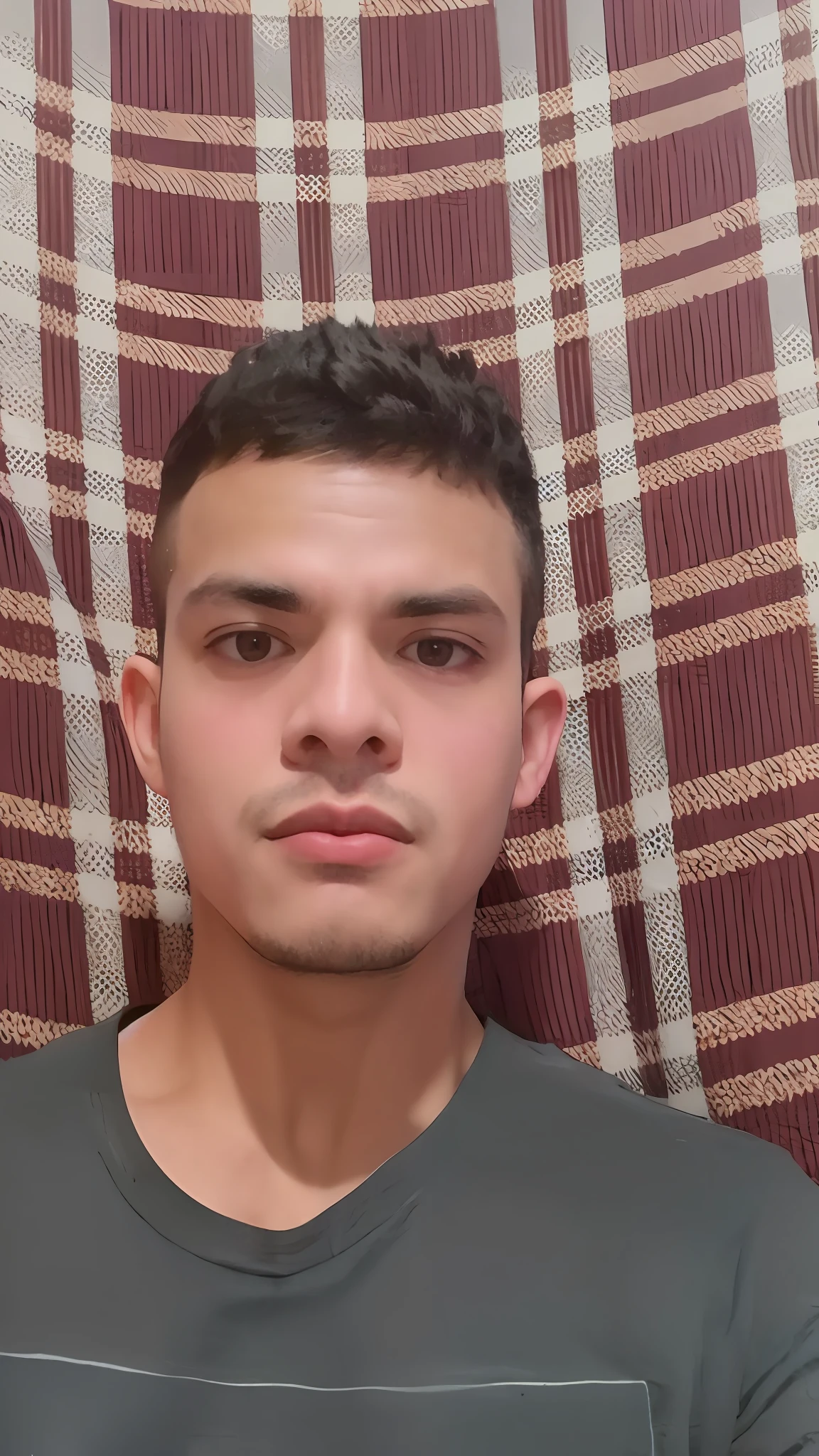 arafed man with a gray shirt and a plaid blanket, around 1 9 years old, 2 3 years old, 2 2 years old, 18 years old, blue symmetric eyes 24yo, 21 years old, 2 4 years old, around 20 yo, 2 7 years old, taken in the early 2020s