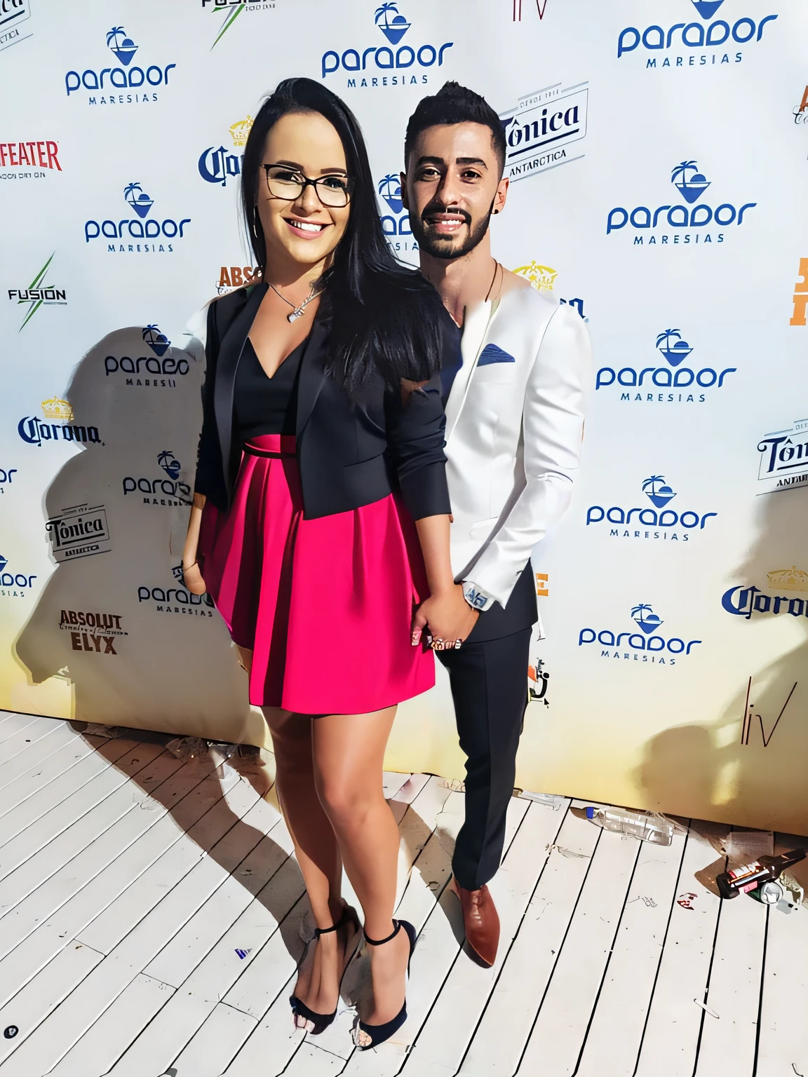 They are posing for a photo on the red carpet, at a wedding party, put a beautiful wedding dress on the woman, on the man on the right put on a beautiful black wedding suit