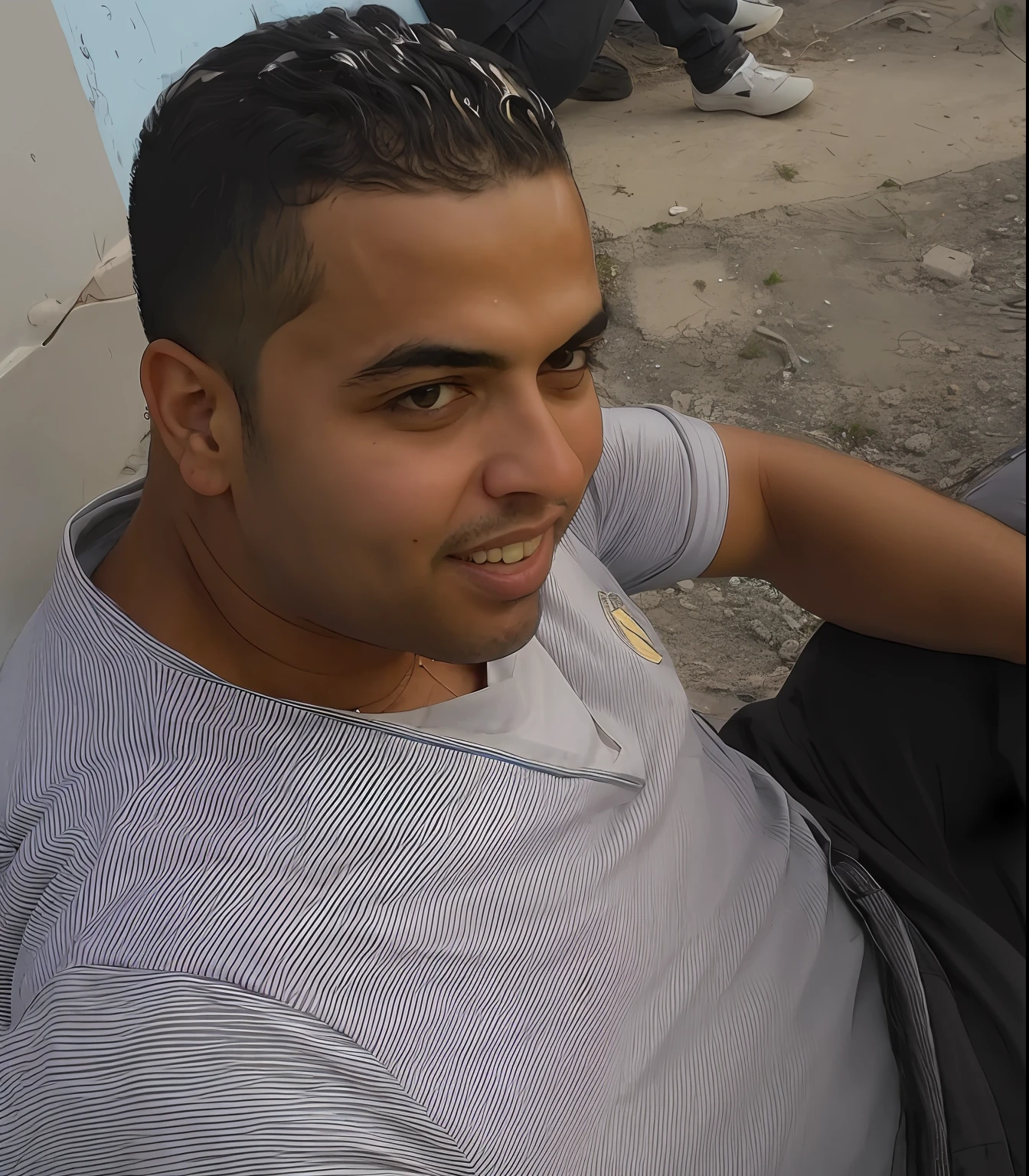 there is a man sitting on the ground with a cell phone, ismail, ronaldo nazario, emad mostaque, mohamed reda, ronaldo nazario fenomeno, riyahd cassiem, mohamed chahin, amr elshamy, taken in the late 2000s, ahmad merheb, saadane afif