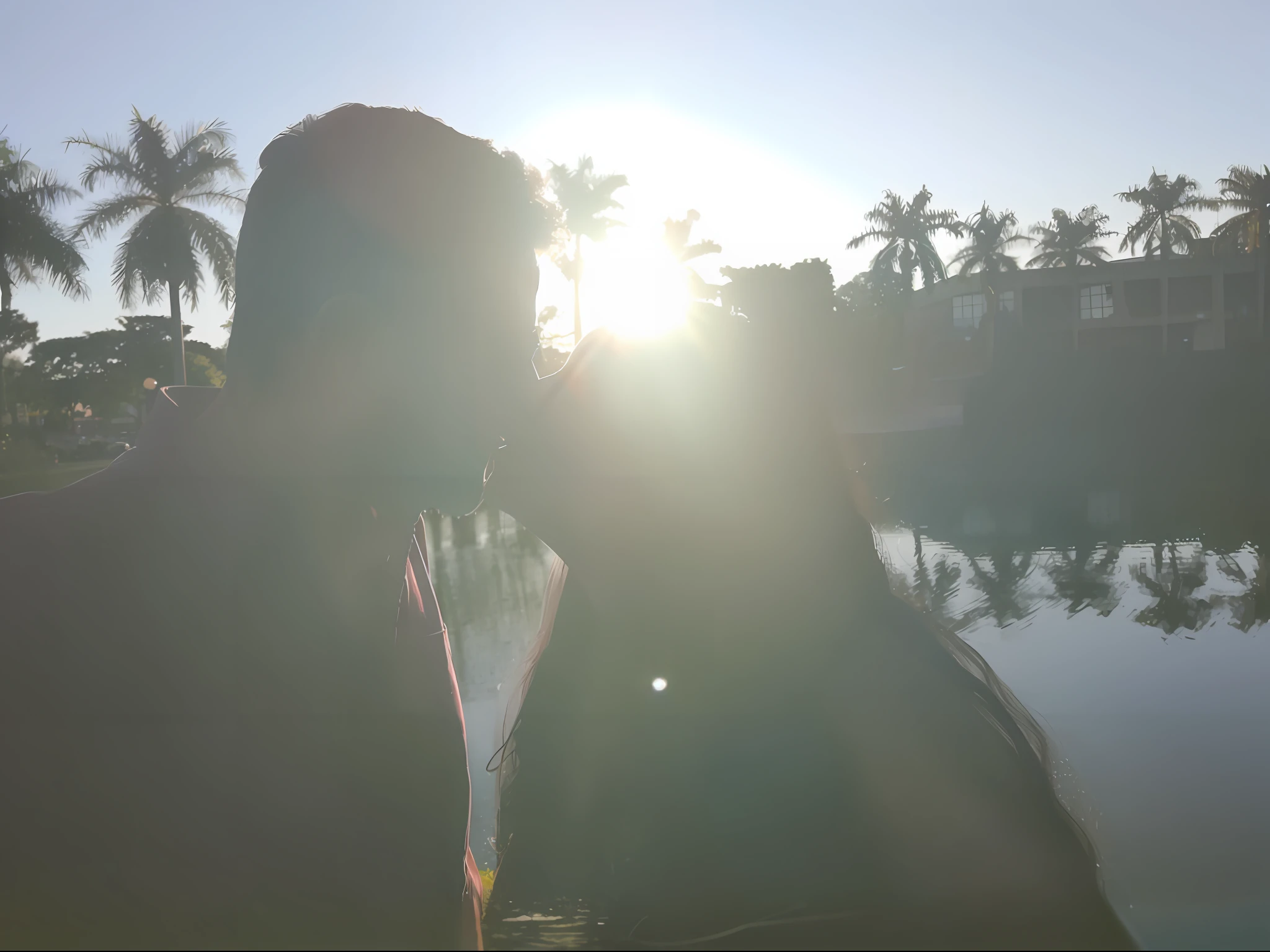There's a man and a woman kissing in front of a lake, during sunset, illuminated!, with the sunset, back to the camera, kissing together in a cute way, sunshine, taken with the best DLSR camera, sunshine, with the sun shining on it, during a sunset,  shining in the sunlight, rays of sun, sun behind him, lion in the background of the image