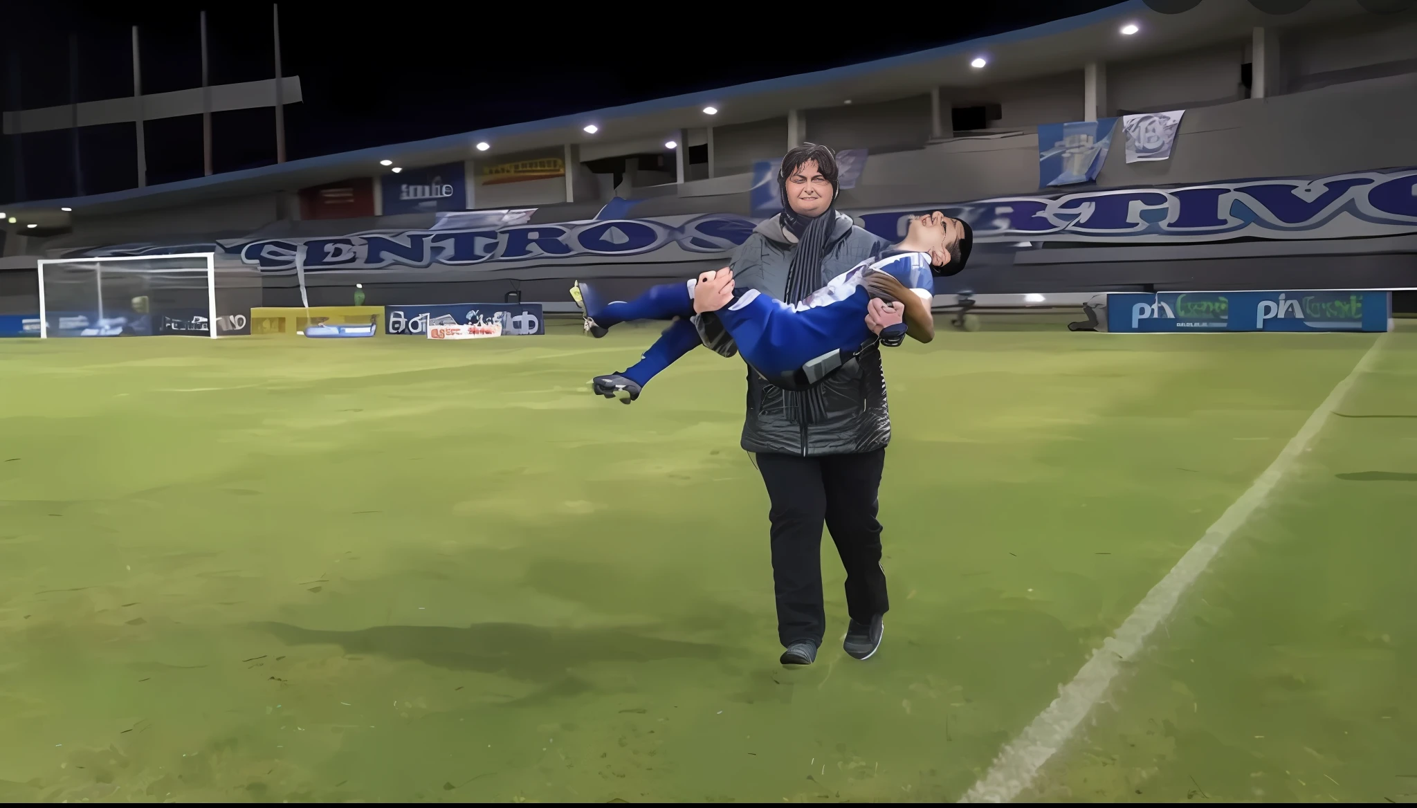 soccer action pose, affection pose, lecherous action pose, dramatic action pose, theatralic pose, there is an attractive woman that is carrying a skinny man, there is a beautiful woman in a shiny coat who is carrying a blond man in her arms, a longhaired beautiful woman in a high-shine black puffy coat, a longhaired woman in a shiny downcoat, a woman is carrying a shorthaired man who is wearing shorts and a t-shirt, a weak man in spots shorts is consciousless and needs to be carried, a shorthaired man with closed eyes is carried in the arms of a longhaired woman, a woman looks very scared and terrified, a consciousless man with closed eyes is suffering very much and has a very painful face, photo, photo shoot, photographed , accident, help, aid, first aid, pity