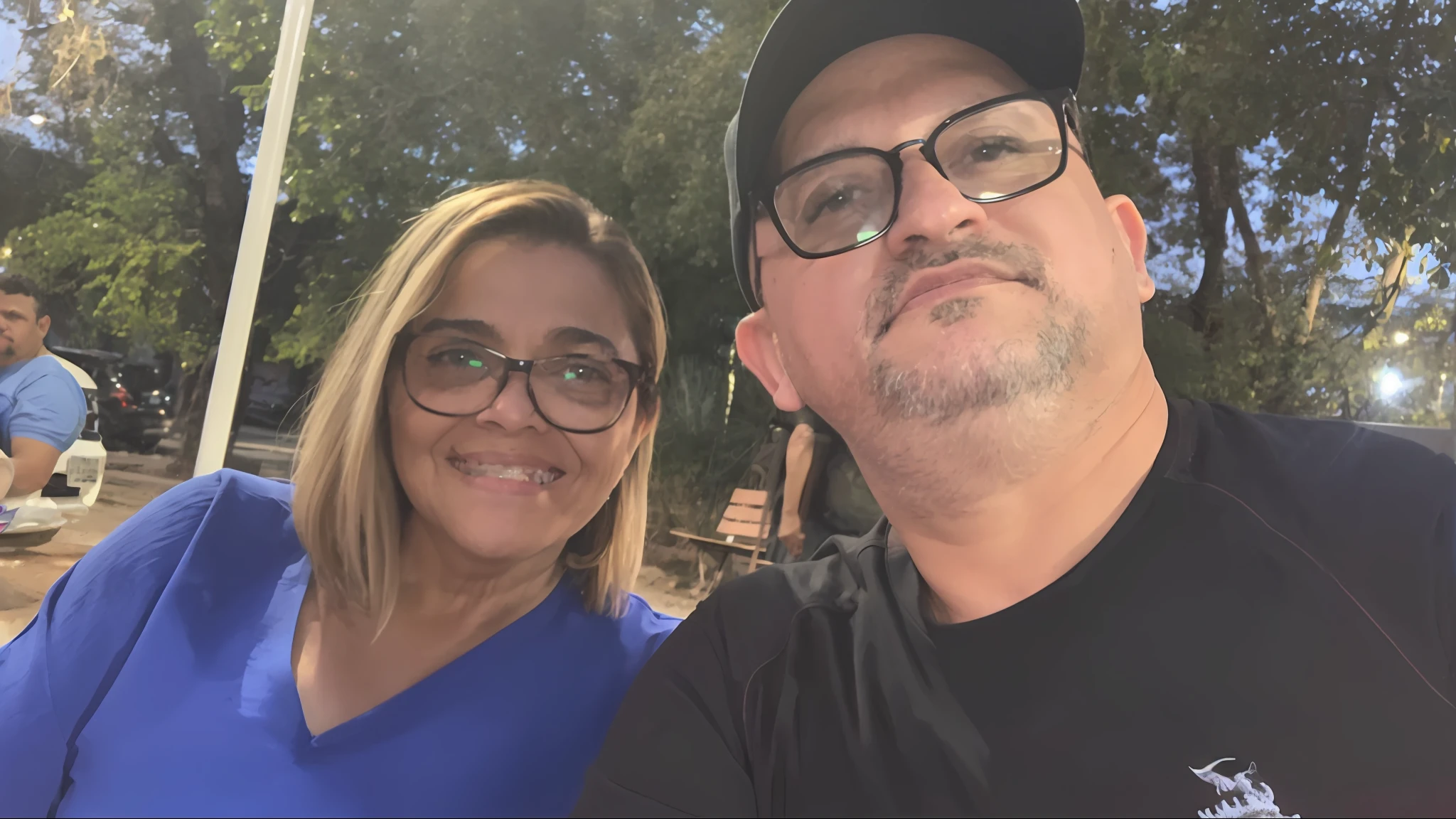 they are sitting at a table outside in the sun, profile image, momma and papa, profile picture, photo taken at night, taken in the early 2020s, karla ortiz, profile pic, avatar image, photo taken in 2 0 2 0, beautiful surroundings, 8k selfie photograph, luis nieves sr, night!