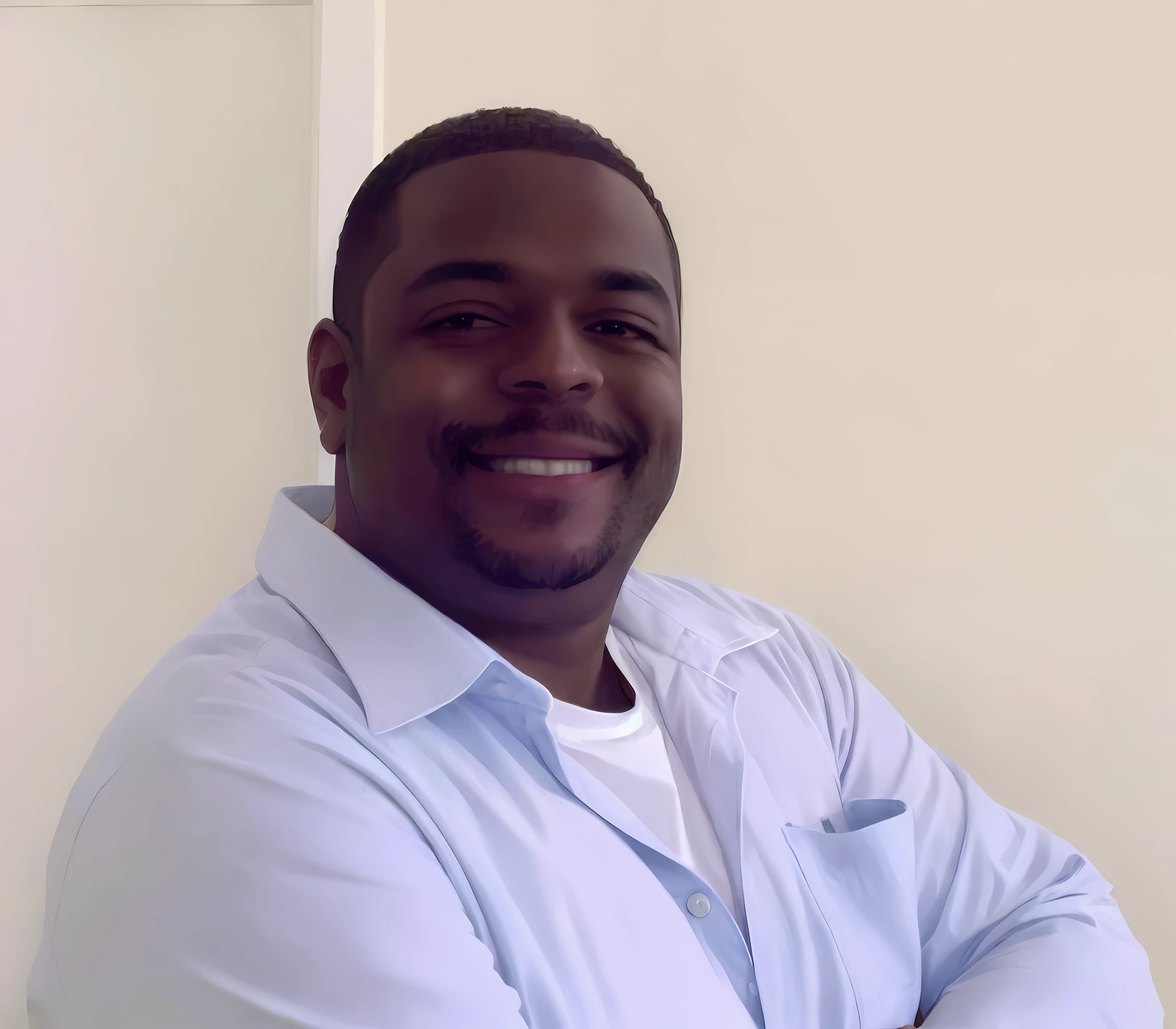 Smiling man in blue shirt with arms crossed