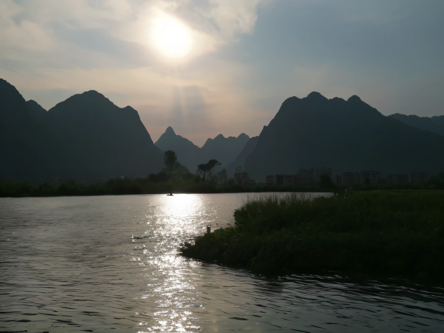 Alafis floats in the river,The background is mountains, karst landscape, very beautiful scenery, very very beautiful scenery, beautiful mountains behind, very very very beautiful scenery, Stunning scenery, mountain in background, mountain in background, sunlight reflected on the river, some mountains in the background, Beautiful scenery, scenery, river in the background