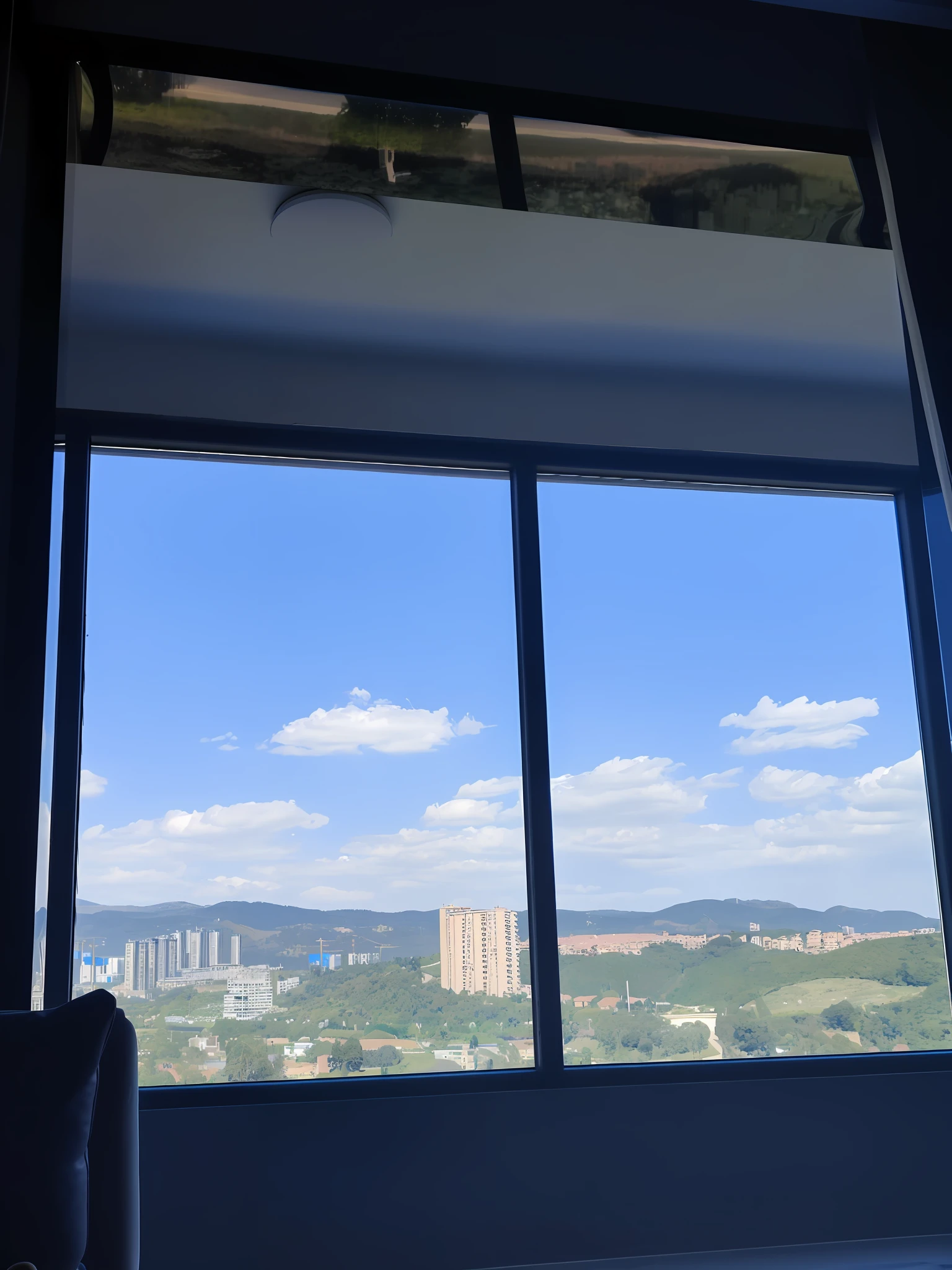 You can see the city from the window of the room, View from the window of the metropolis, looked at big window, Windows and city background, 8 k''. filling of the view, skyline showing from the windows, View from the window, View through the window, window view, View outside the window, window in foreground, Shooting with Sony A7R cameras adds mountains and clouds