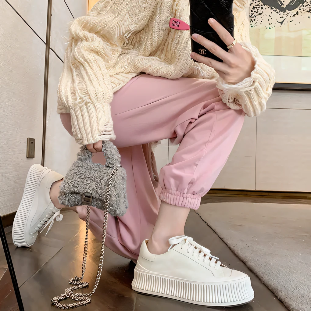 The Aravi woman sat on the floor,Hold your wallet and phone, high waist sweatpants, inspo, Cute casual streetwear, white trendy clothes, in pastel shades, wearing a pastel pink hoodie, Wearing white sneakers, Pink, in pastel shades, Mellow Atmosphere, white and light-pink outfit, Pastel style, In pastel colors, Pink shoes, feminine in cute pastel shades