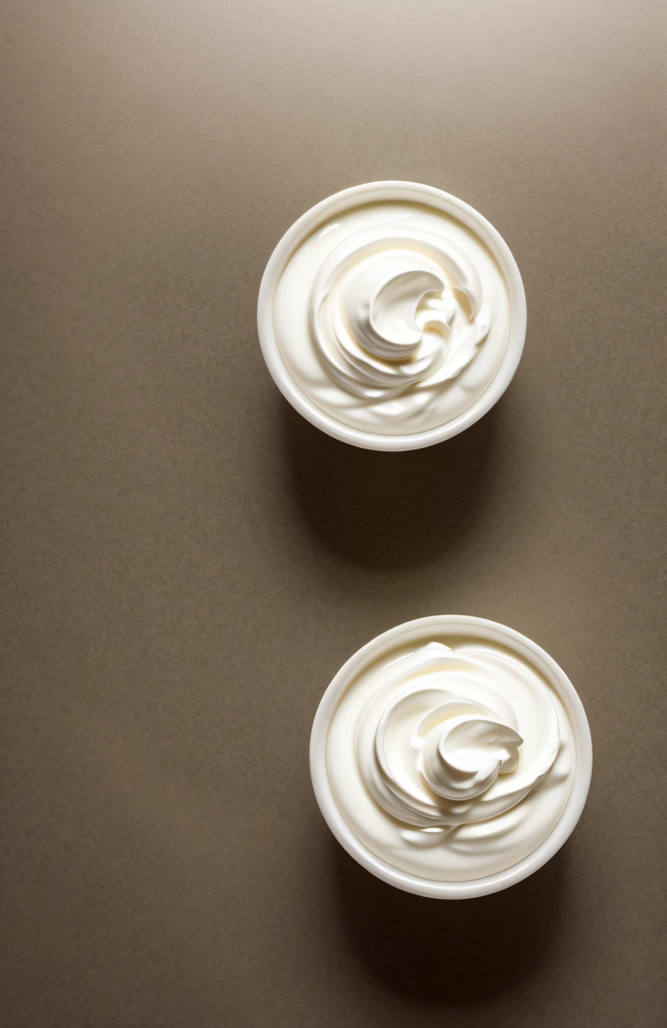 "In a clean and inviting kitchen setting, witness the essence of Greek yogurt come to life in this stunning photograph. The minimalist backdrop accentuates the purity of this wholesome treat."