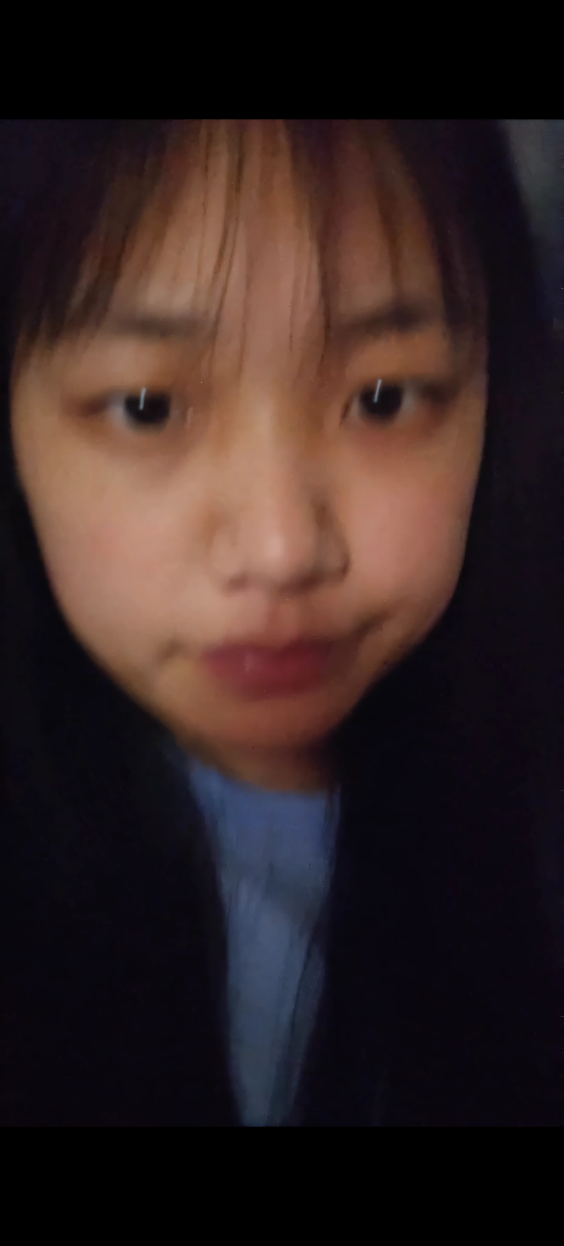 There was a woman in a black jacket and a blue shirt, She has a cute face, She is facing the camera, Face picture, Asian face, Detailed unblurred face, with small nose, 8k selfie photograph, zoom in on face, with round face, pale round face,ultraclear,Sexual suggestiveness,exhilarated