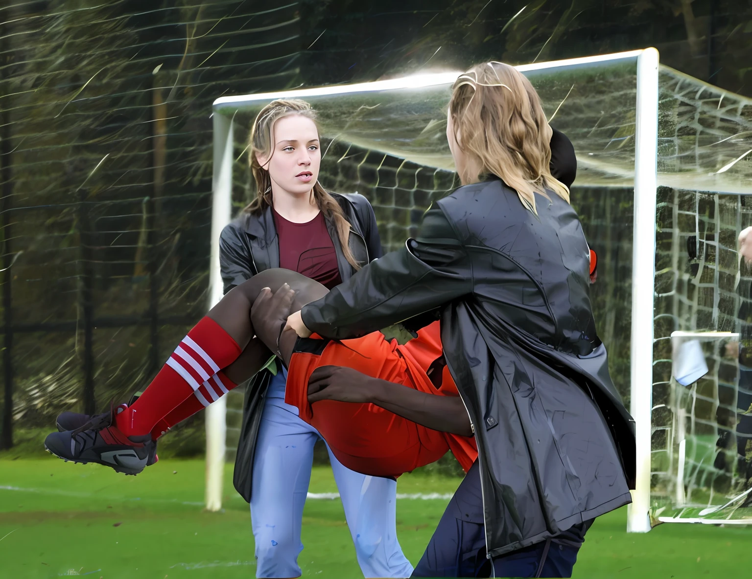 rainy weather, cool weather, humid conditions, soccer action pose, affection pose, sports injury scene, women carrying a consciousless man in their arms, injured male soccer player, young female medics in high-shine latex-coats, a hurt male soccer player is being carried in the arms of two longhaired female medics in shiny coats, lecherous action pose, dramatic action pose, theatralic pose, there are two female medics in wetlook shiny coats with long hair, an injured sportsman in matte sportswear is carried away by two female medics, two female medics are carrying in their arms an injured sportsman in very matte sportswear, an injured sportsman in very matte sportswear is carried from the pitch by two female medics, a man is carried in the arms of two women, longhaired female medics are carrying a wounded sportsman in their arms, longhaired beautiful female medics in high-shine coats, women are carrying a shorthaired man who is wearing shorts and a t-shirt, a weak man in matte sportswear is consciousless and needs to be carried, a hurt soccer player in a matte cotton sports outfit is rearing up in pain in the arms of two women, a shorthaired man with closed eyes is carried in the arms of longhaired women, the women look very scared and terrified, a consciousless man with closed eyes is suffering very much, photo, photo shoot, photographed , accident, help, aid, first aid, pity, very painful face