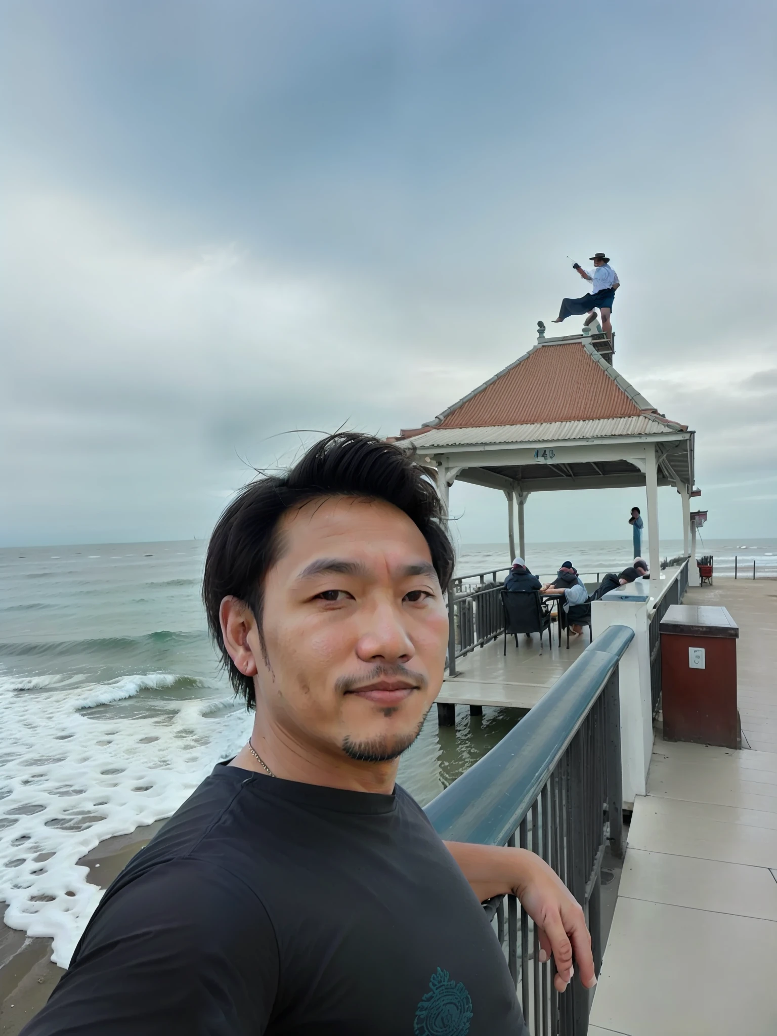 there is a man standing on a pier looking at the camera, the ocean in the background, ocean in the background, at the sea, 4 0 years old man, standing near the beach, thawan duchanee, dzung phung dinh, 8k selfie photograph, sea in the background, at the seaside, very accurate photo