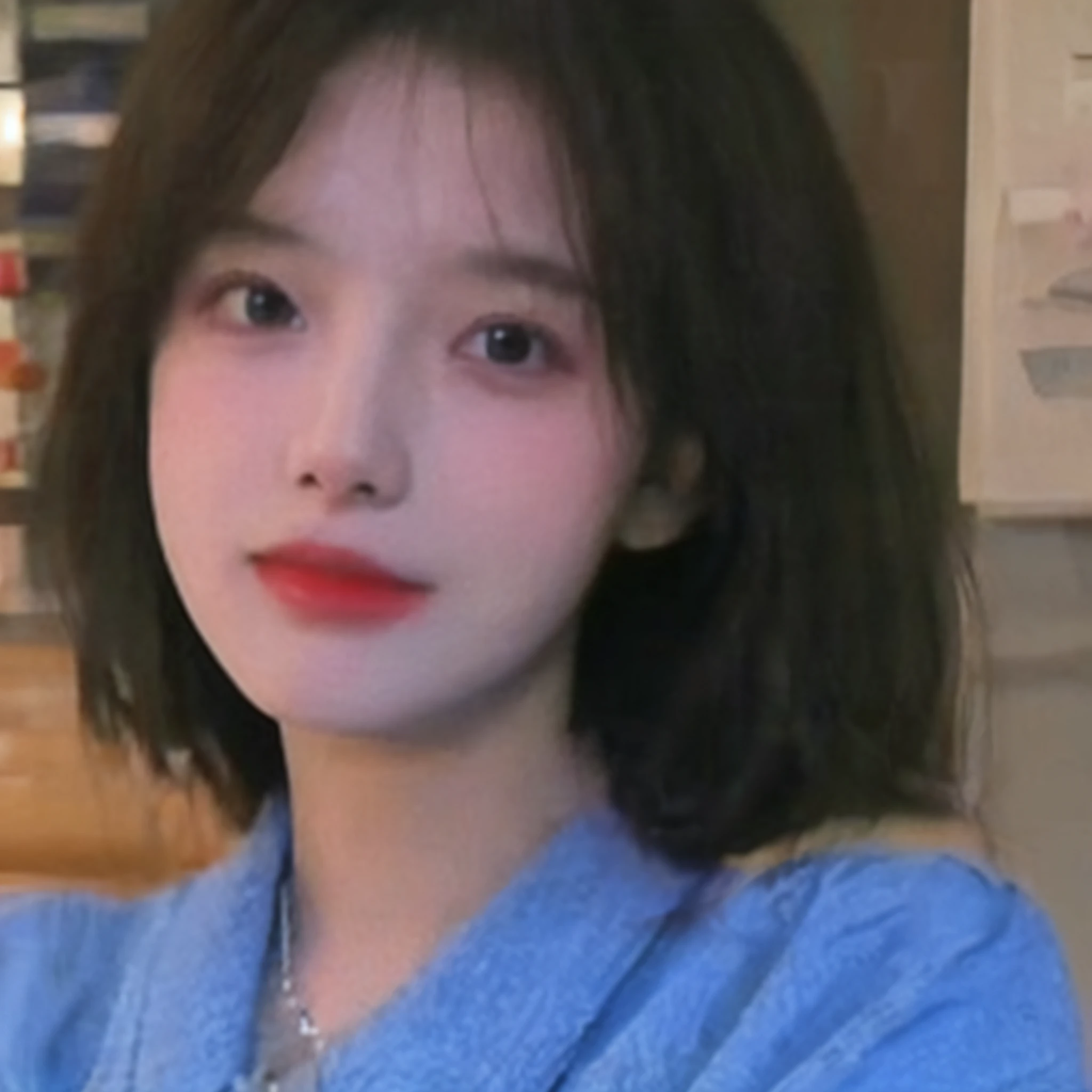 a close up of a woman with a blue shirt and a red lipstick, ulzzangs, wan adorable korean face, with round face, with short hair, pale round face, young lovely Korean faces, Korean girl, She has a cute face, 19-year-old girl, Small round face, young cute wan asian face, south east asian with round face
