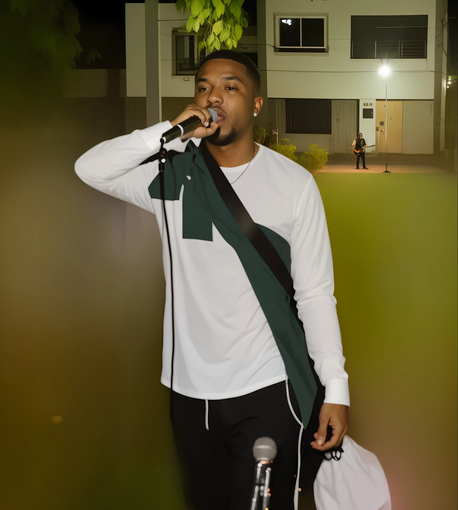 There's a man standing in the grass with a microphone, Apresentando-se no palco, rap no palco do festival, rap no microfone, vocalista, Rap, Album art, live performance, Executando um videoclipe, Executar, taken in the night, album, durante a noite, rapper, videoclipe, night time, banda, photo shoot, concerto, aceso de lado