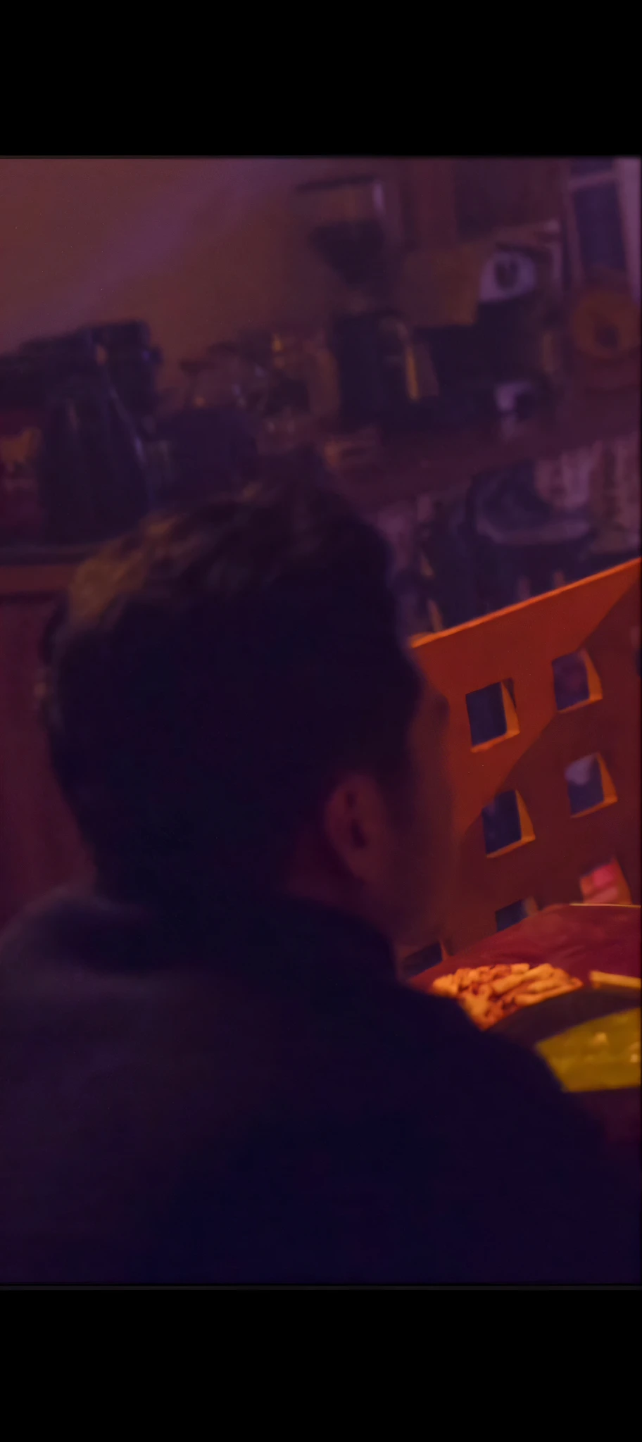 there is a man sitting at a table with a remote control, grainy low quality, candid shot, movie scene close up, still frame from a movie, movie screen shot, some zoomed in shots, screenshots from movies, haze over the shoulder shot, looking to his left, vhs screencap, low quality grainy, grainy movie still, low quality footage
