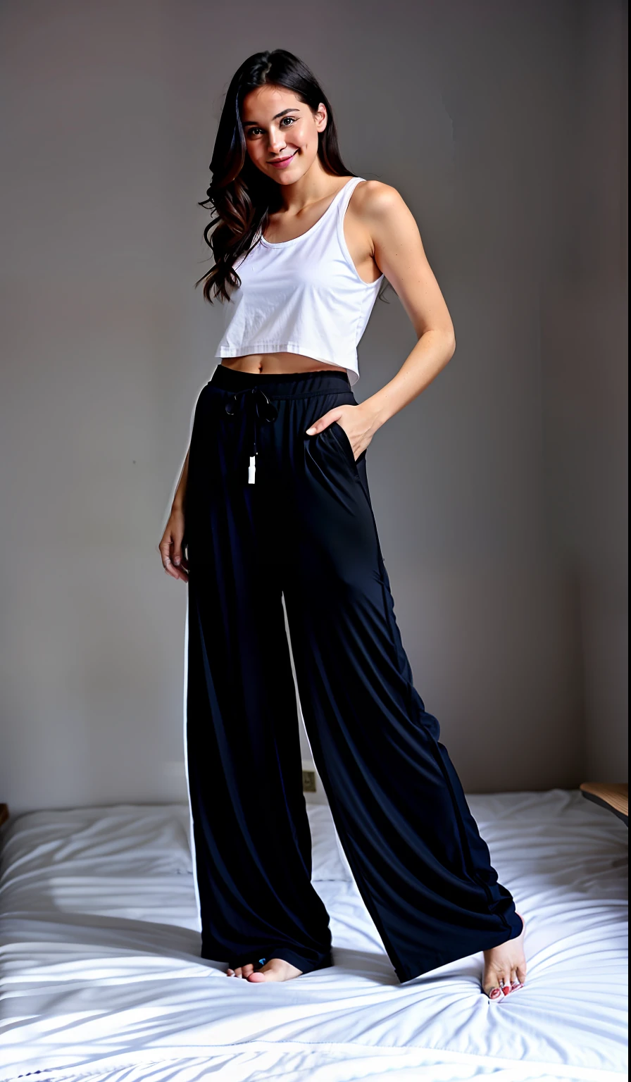 Pajama model with black pants and white tank top, bare foots