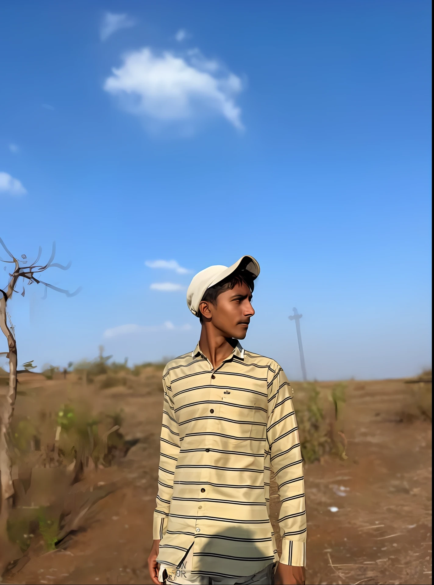 arafed man standing in a field with a hat on, standing in a barren field, distant full body view, profile pic, photo taken in 2 0 2 0, in a vast serene landscape, absolutely outstanding image, farmer, looking away from camera, a handsome, shot on iphone 1 3 pro max, mixed art, in front of a forest background